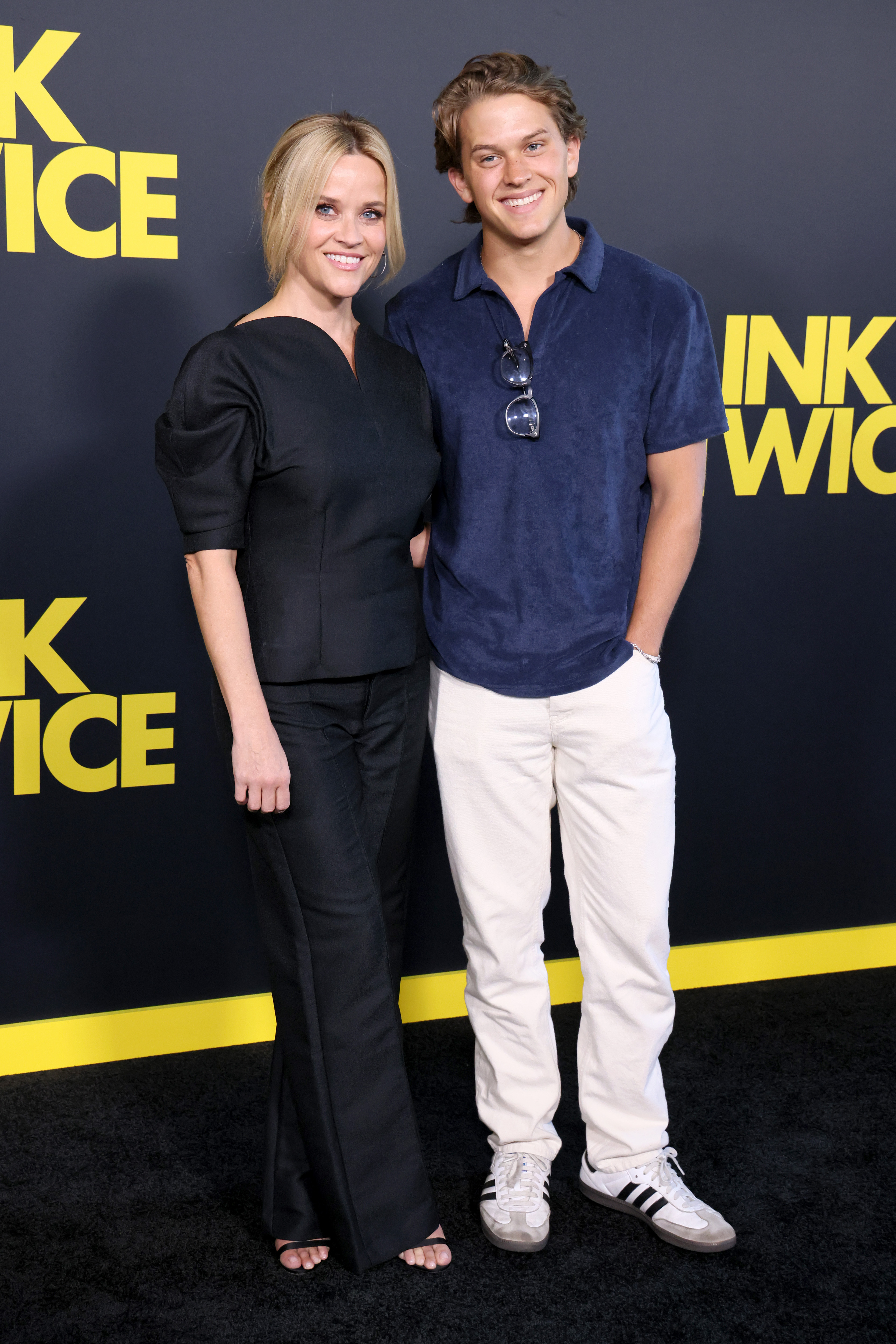 Reese Witherspoon and Deacon Phillippe attend the Los Angeles premiere of Amazon MGM Studios' "Blink Twice," smiling together against the film's bold black-and-yellow backdrop. | Source: Getty Images