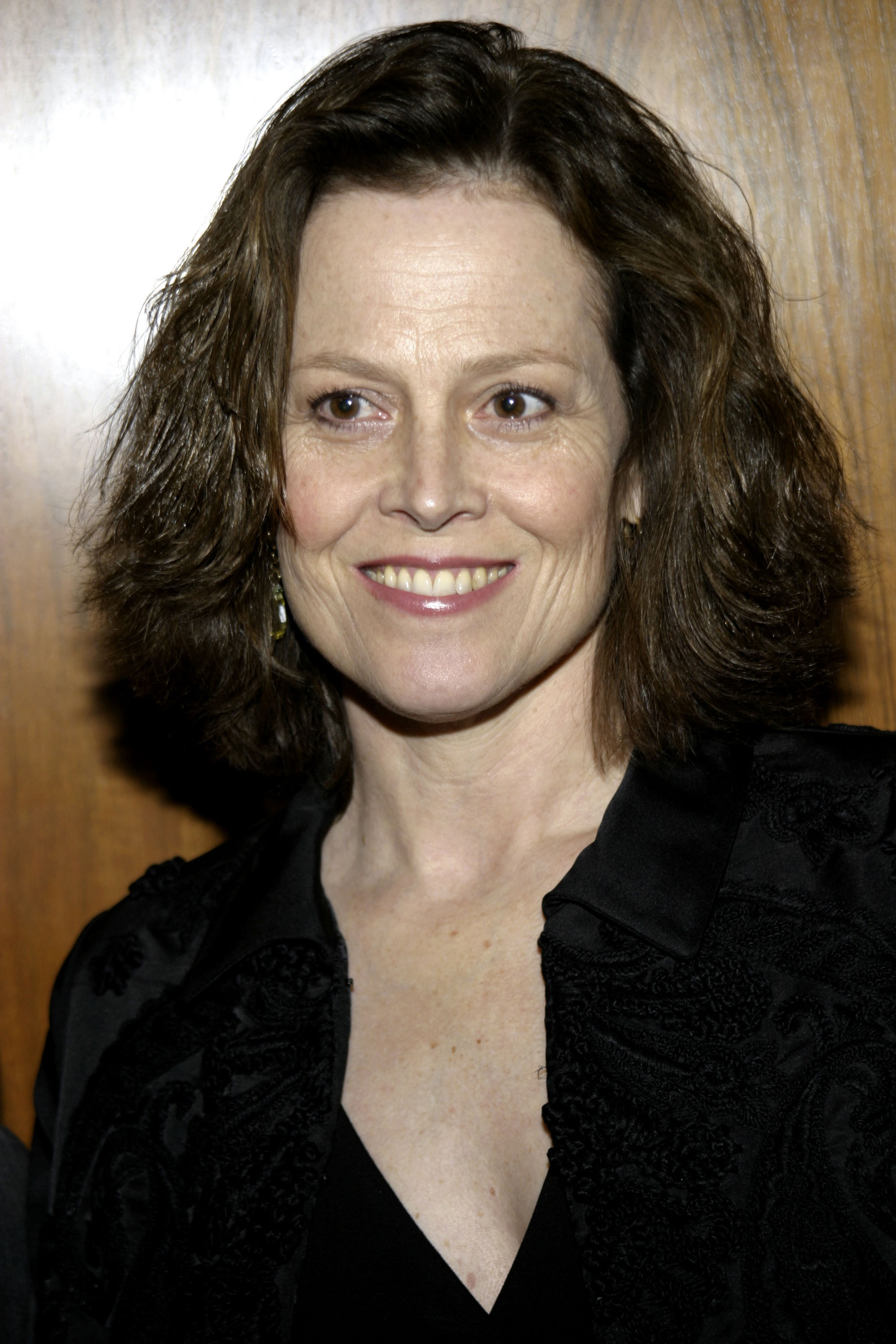 Sigourney Weaver attends a fashion event in New York City, smiling in a close-up portrait against a neutral background | Source: Getty Images