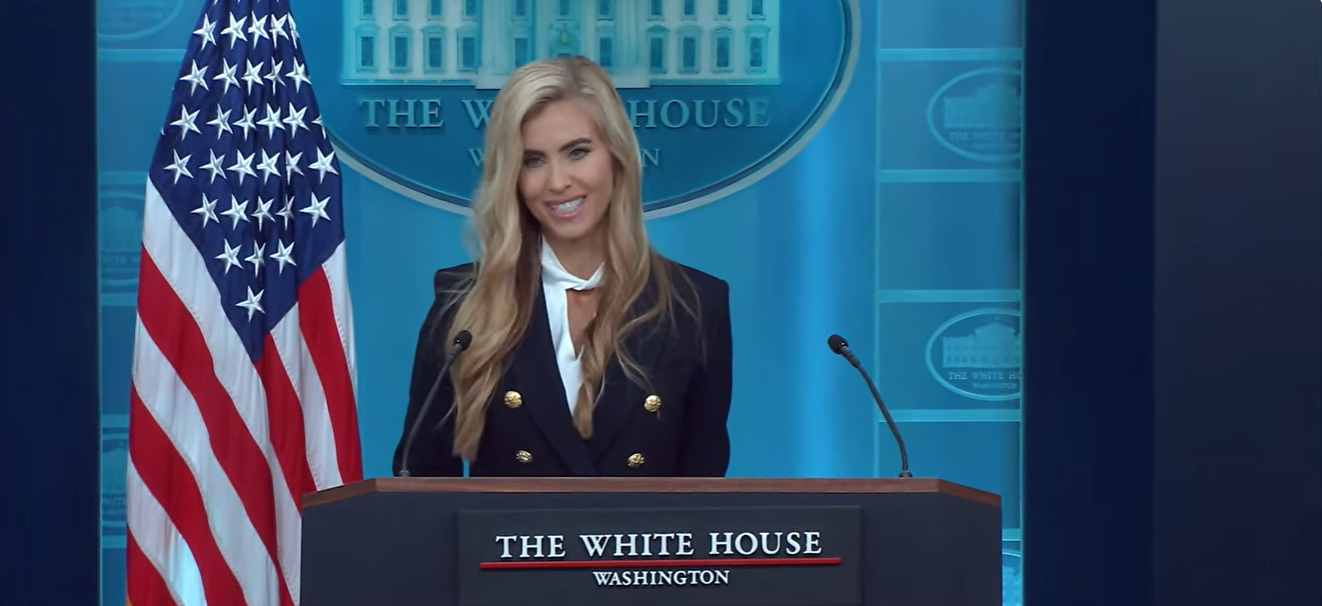 Katie Zacharia smiles while addressing reporters during her first White House press briefing, a moment later examined by behavioral experts who questioned the timing of her expressions. | Source: YouTube/The White House