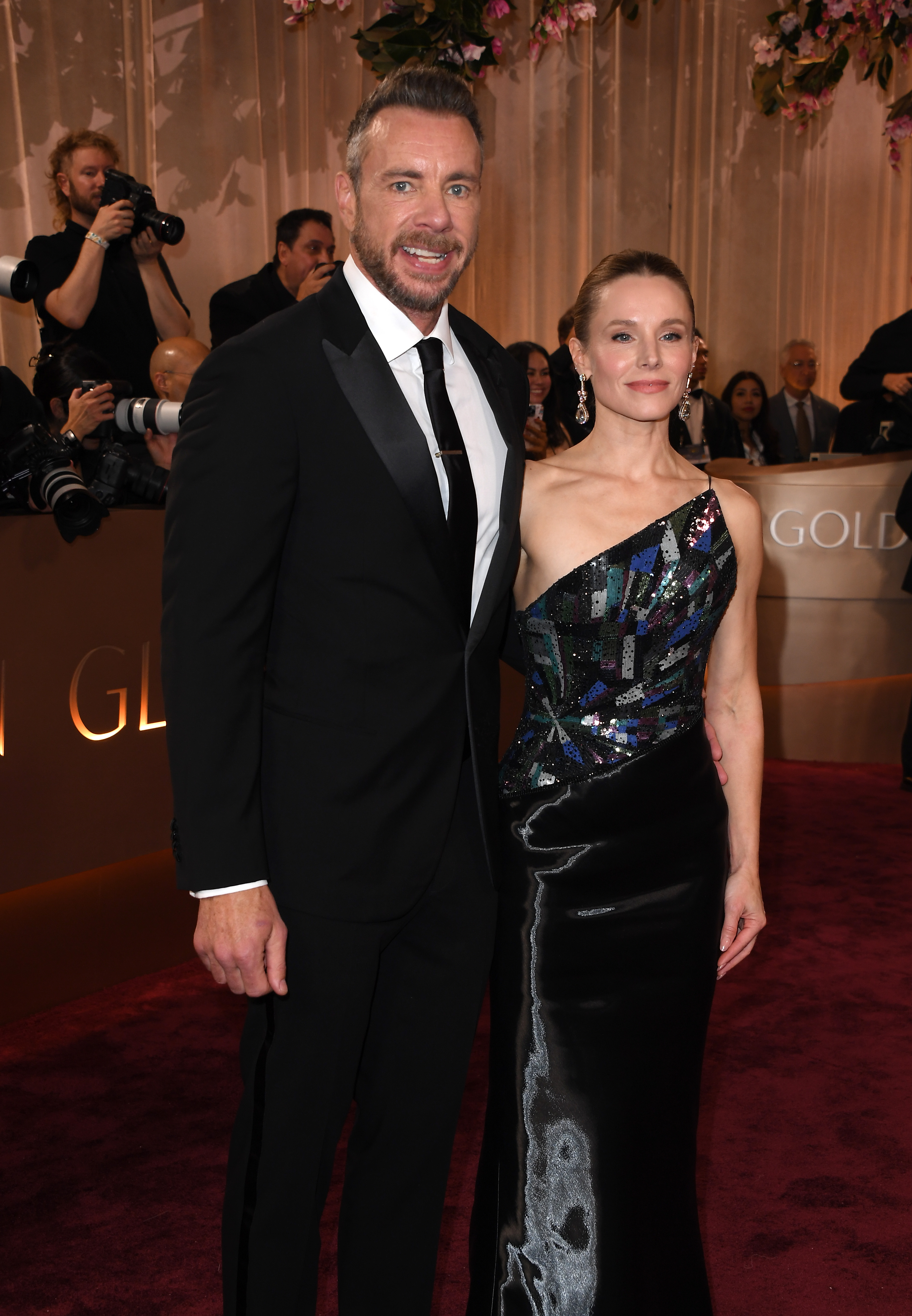 Dax Shepard and Kristen Bell strike a polished pose at the 83rd Golden Globe Awards. Bell's shimmering one-shoulder gown and Shepard's sleek tux make them a standout pair on the red carpet.