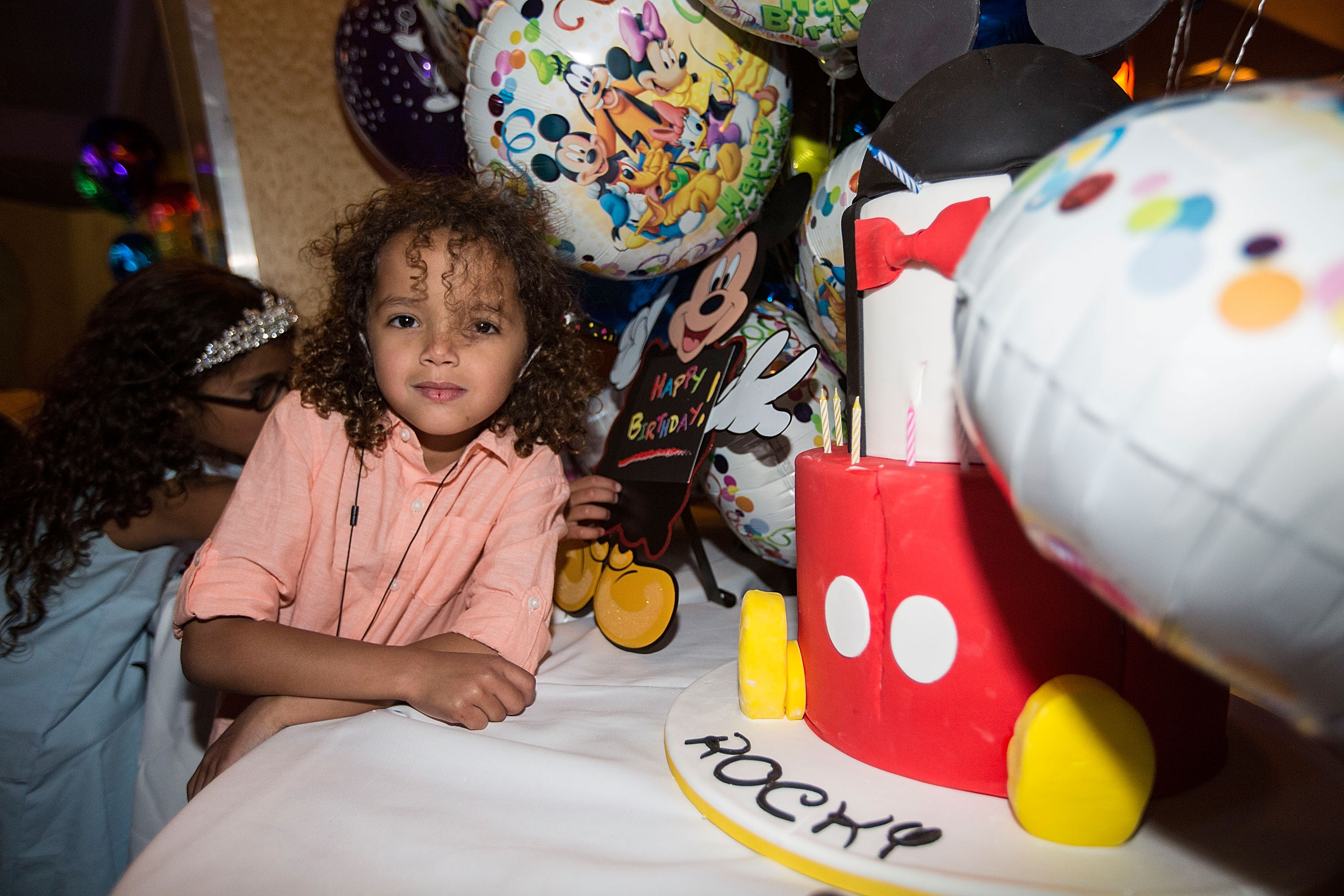 Moroccan Cannon, aged 6, poses next to his birthday cake at Disneyland on April 30, 2017, in Anaheim, California. He celebrates his "Dem Babies Sixth Birthday Bash" alongside his twin sister Monroe Cannon, hosted by his parents.