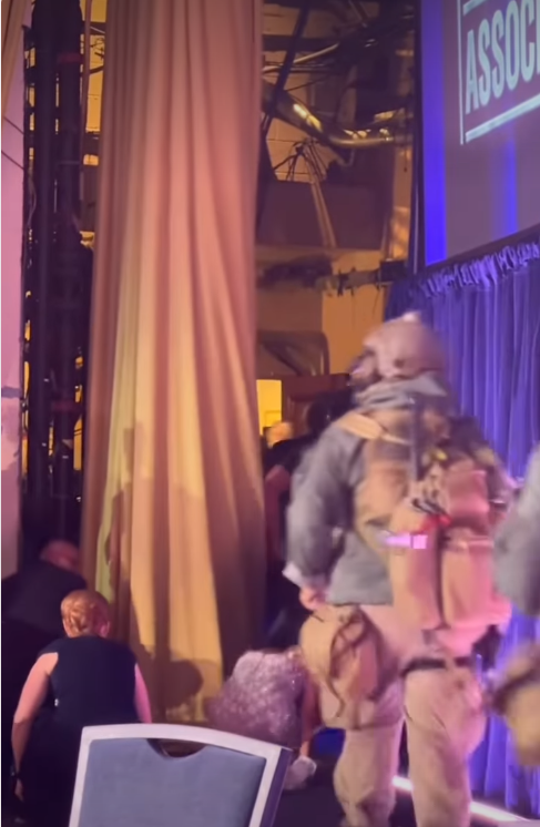 Guests at the White House Correspondents’ Dinner duck and scramble for safety, some crouching behind chairs and tables. | Source: Instagram/hellomag