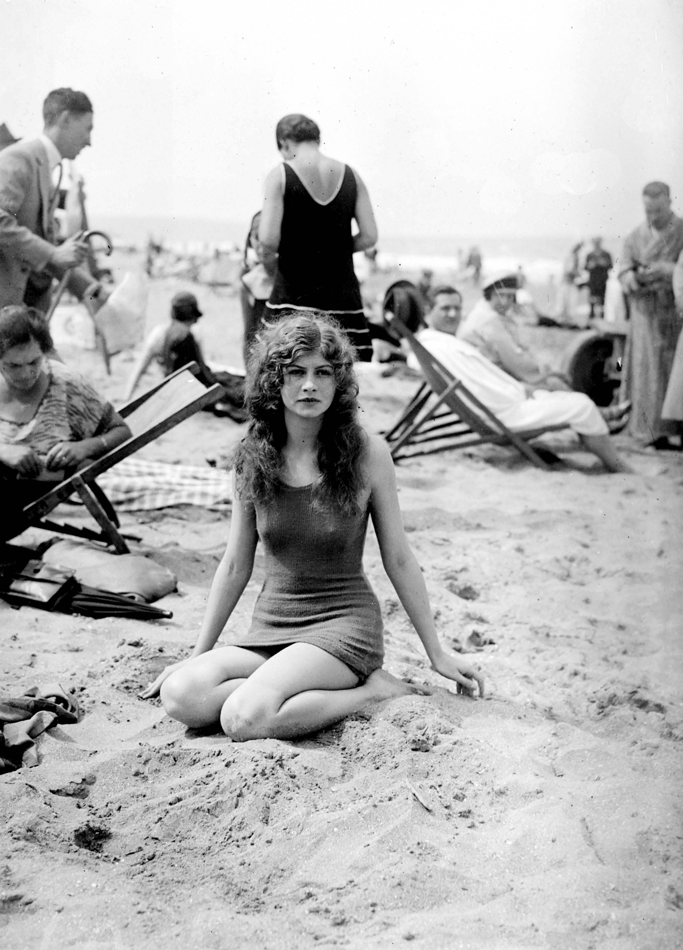 Woman sitting on Deauville beach | Source: Getty Images