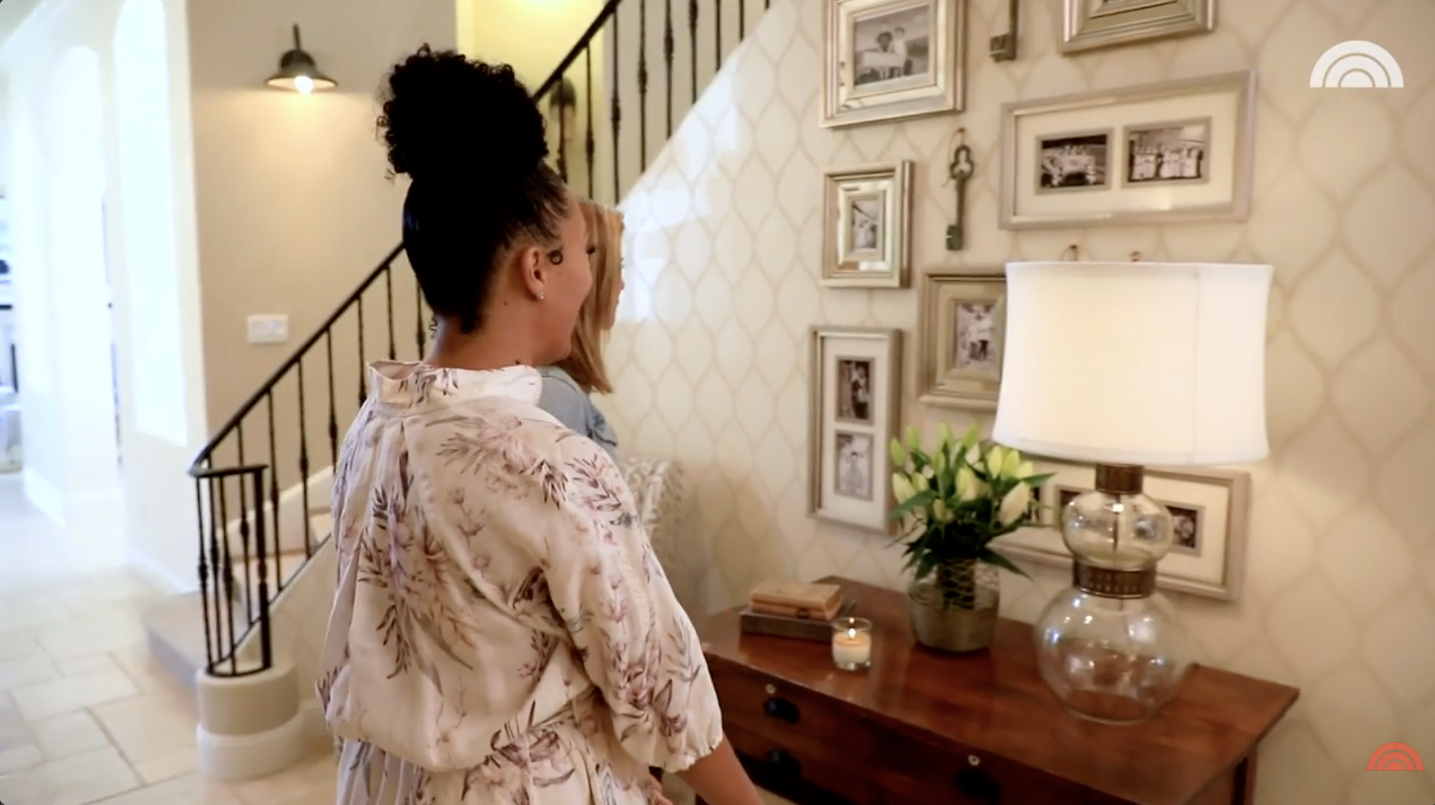 Tamera Mowry showing her family photo wall to a "Today" correspondent during a home tour. | Source: YouTube/Today