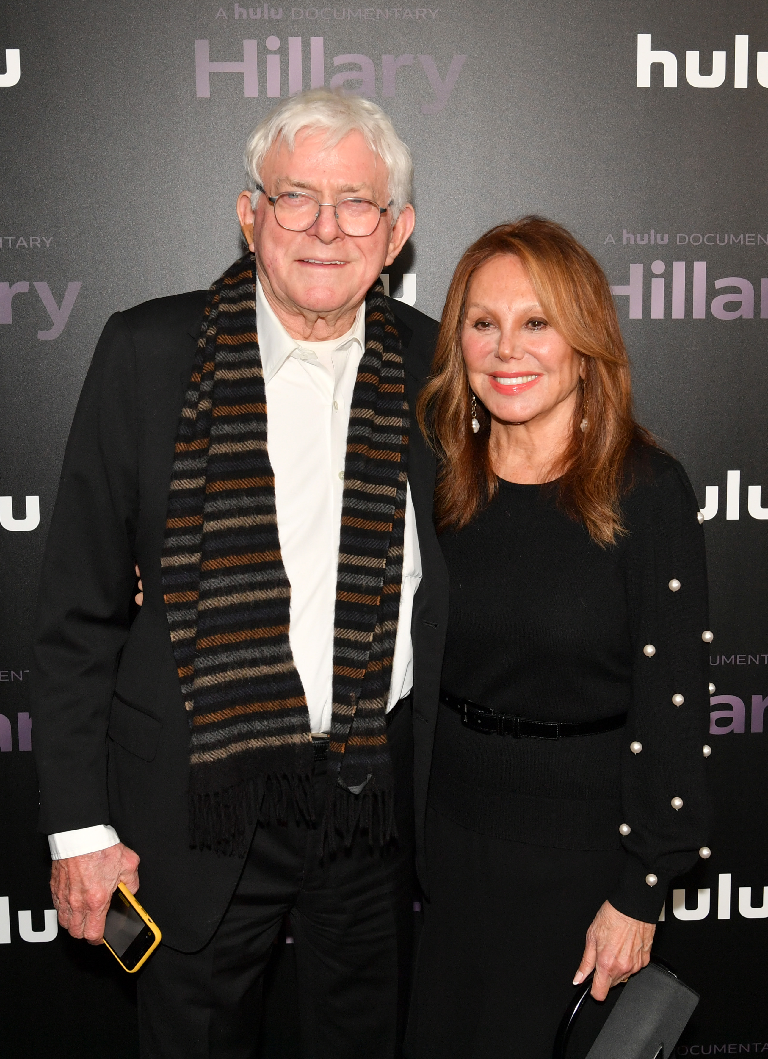 Phil Donahue and Marlo Thomas attend the premiere of Hulu's "Hillary" documentary in New York City, posing together on the arrivals carpet. | Source: Getty Images