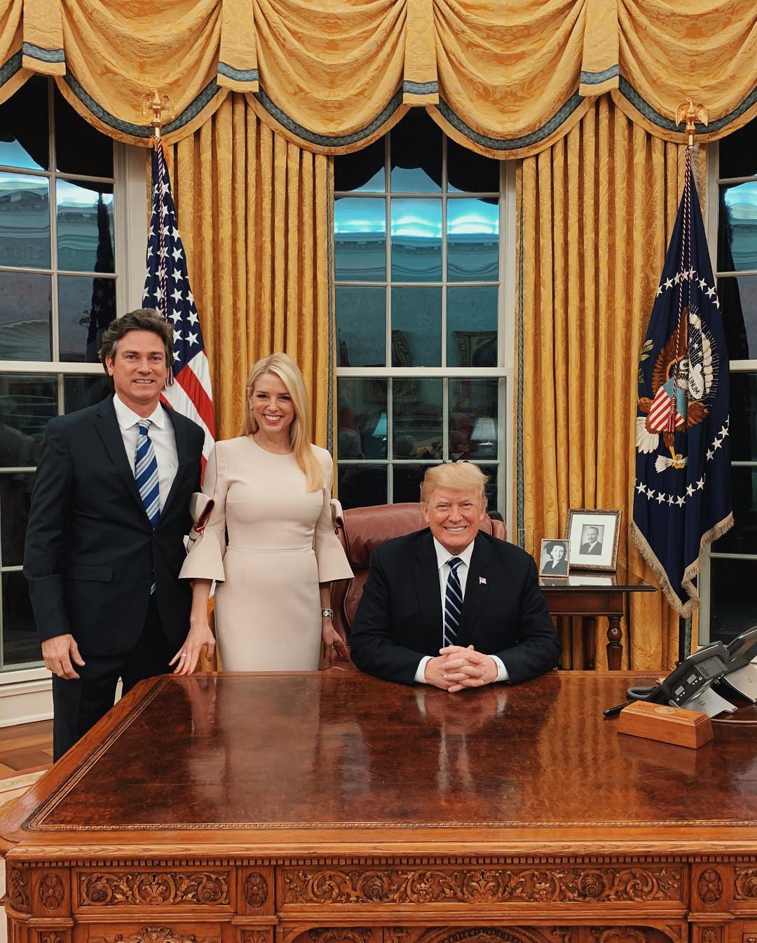 Pam Bondi and John Wakefield pose for a photo with Donald Trump inside the Oval Office | Source: Instagram.com/pambondi