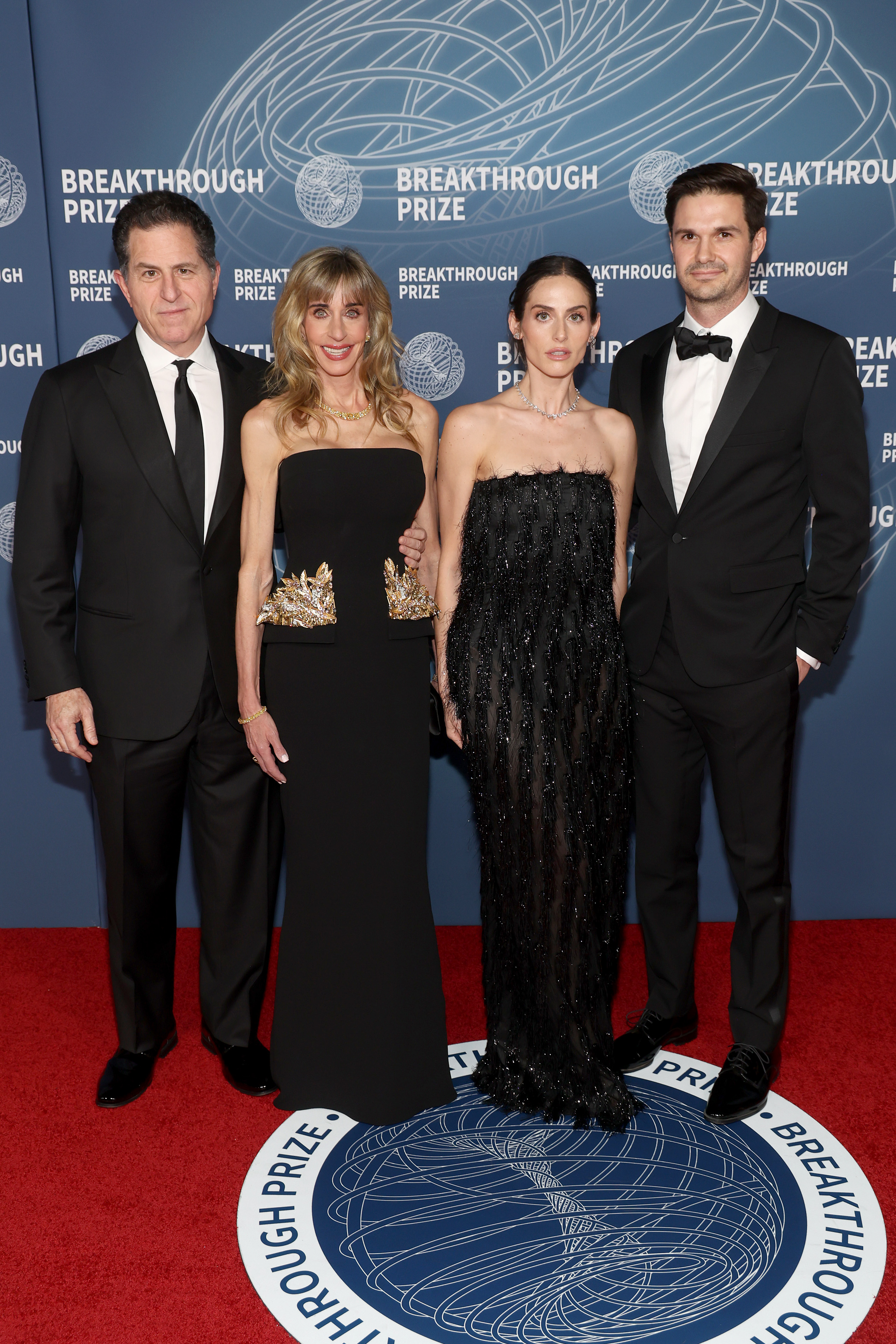 Susan Dell attends the 11th Breakthrough Prize Ceremony at Barker Hangar in Santa Monica, California, alongside her husband Michael Dell, daughter Alexa Dell and Fred Choquette. Susan wore a strapless black gown featuring striking gold embellishments at the waist.