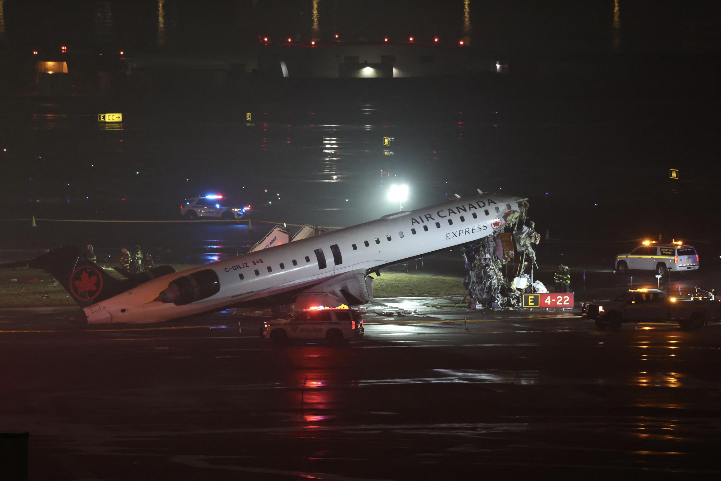 Emergency personnel respond to an Air Canada Express CRJ-900 on the runway after colliding with a Port Authority fire truck at LaGuardia Airport on March 23, 2026, in New York City | Source: Getty Images
