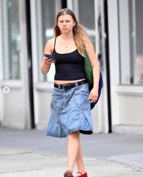 Matilda Ledger is seen walking through New York City during her August 2025 outing, wearing a black tank top, a knee-length denim skirt, and red flats while carrying her phone. The rare sighting sparked widespread discussion online, with many saying she resembled both her late father, Heath Ledger, and his "10 Things I Hate About You" co-star Julia Stiles. | Source: Instagram/Page Six