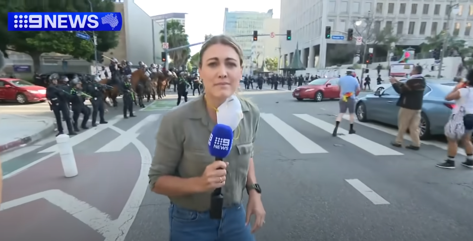 Lauren Tomasi reporting from Downtown Los Angeles during confrontations between the U.S. National Guard and protestors on June 8, 2025 | Source: Youtube/9 News Australia