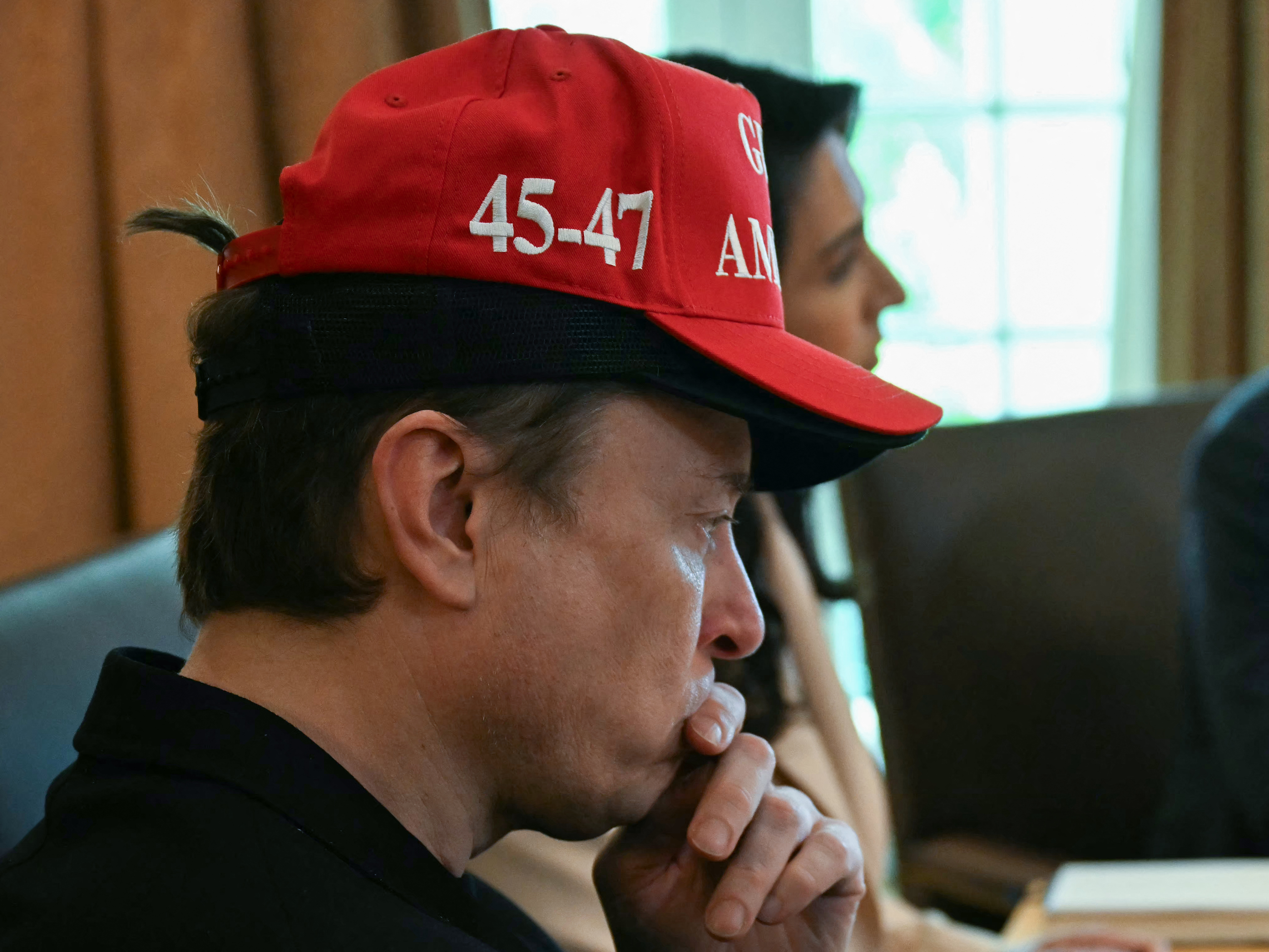 Elon Musk wearing a cap written "45-47" | Source: Getty Images