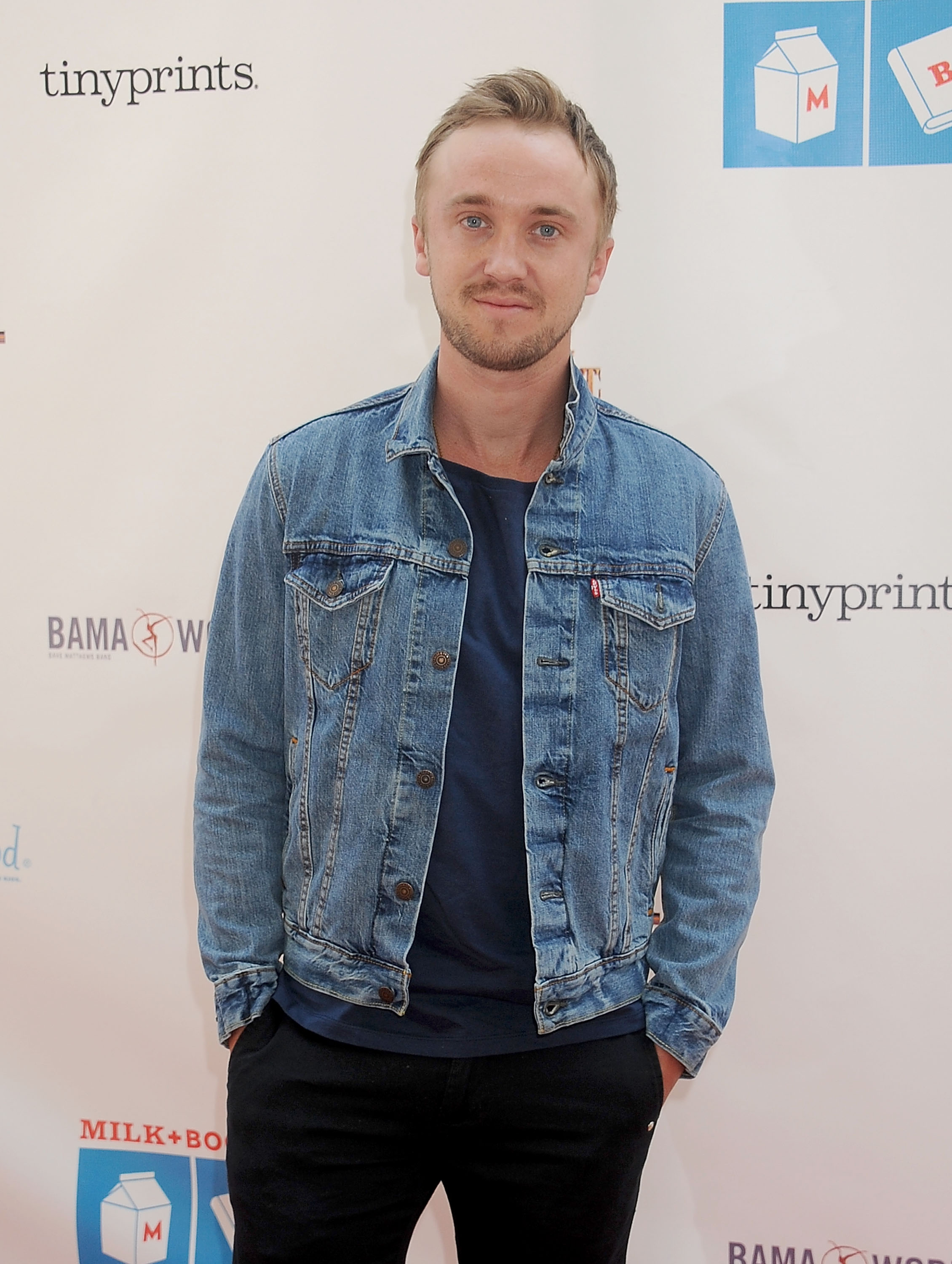 Stepping out in a relaxed denim look, bringing easy charm to the Milk + Bookies 6th Annual Story Time Celebration's cheerful atmosphere, Tom Felton's casual confidence pairs effortlessly with the playful, kid-friendly spirit of the event. At the function, he blends star power with a down-to-earth warmth.