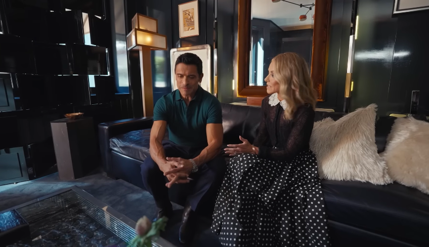 The couple's presence makes the dark room feel more personal than intimidating. Their banter gives context to design choices that might otherwise feel extreme. | Source: YouTube/Architectural Digest
