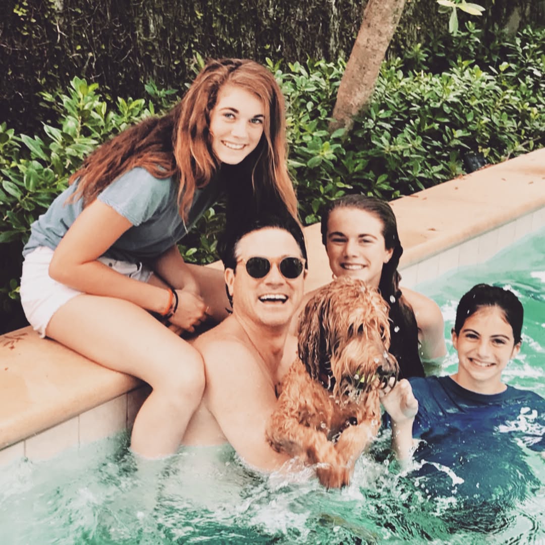 John Wakefield pictured relaxing in a pool with children and a dog | Source: Instagram.com/pambondi