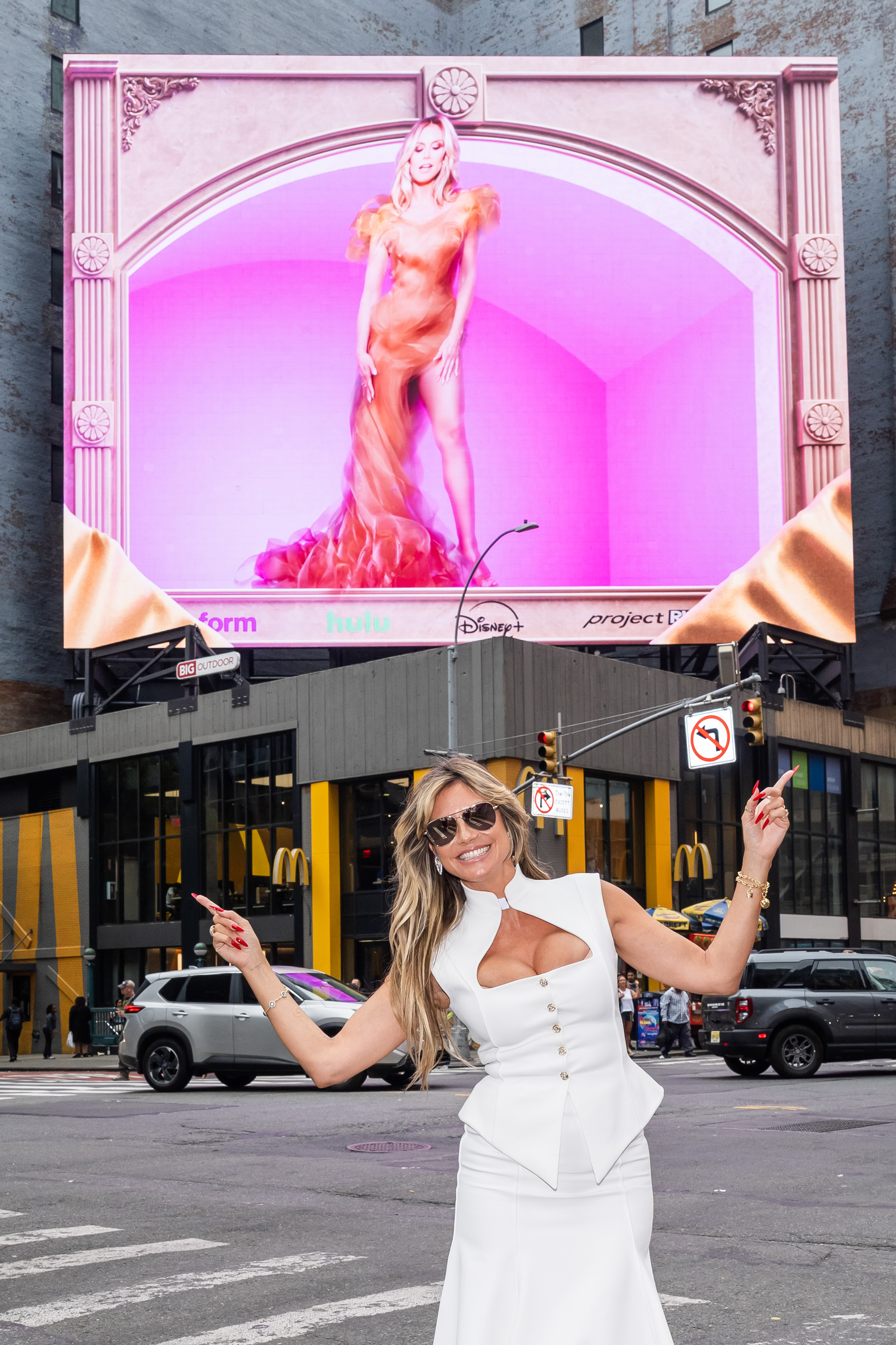 Heidi Klum points at her "Project Runway" billboard in Times Square on August 6, 2025, in New York City | Source: Getty Images