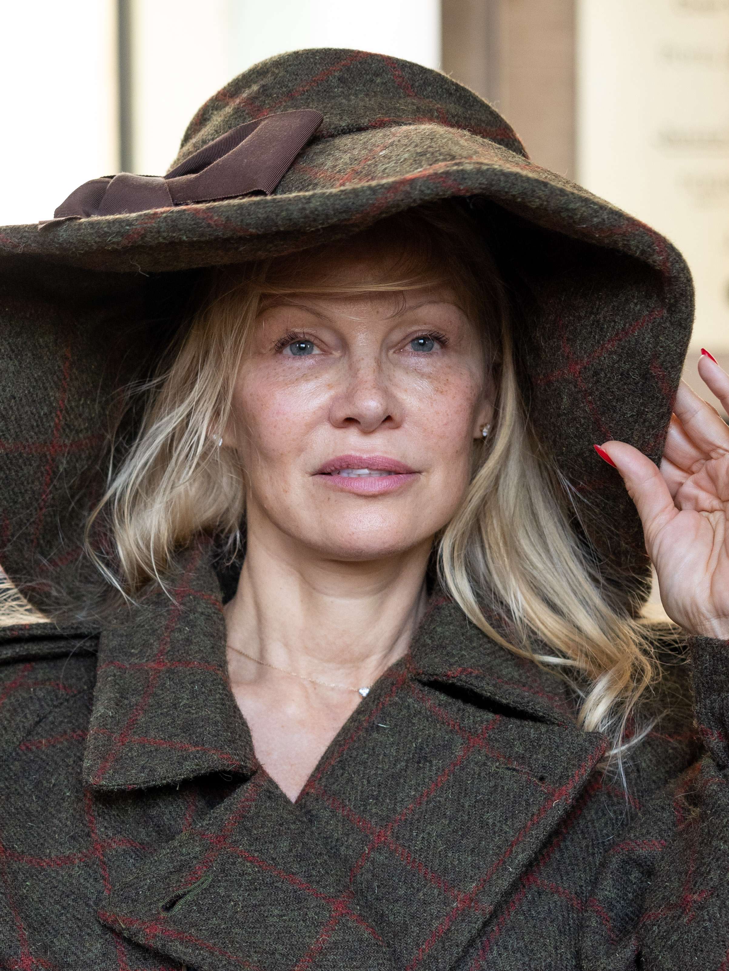 Pamela Anderson attends the Vivienne Westwood Womenswear Spring/Summer 2024 show in Paris on September 30, 2023. Wearing a wide-brimmed hat, she continued the pared-back beauty approach that became a talking point during Fashion Week. | Source: Getty Images
