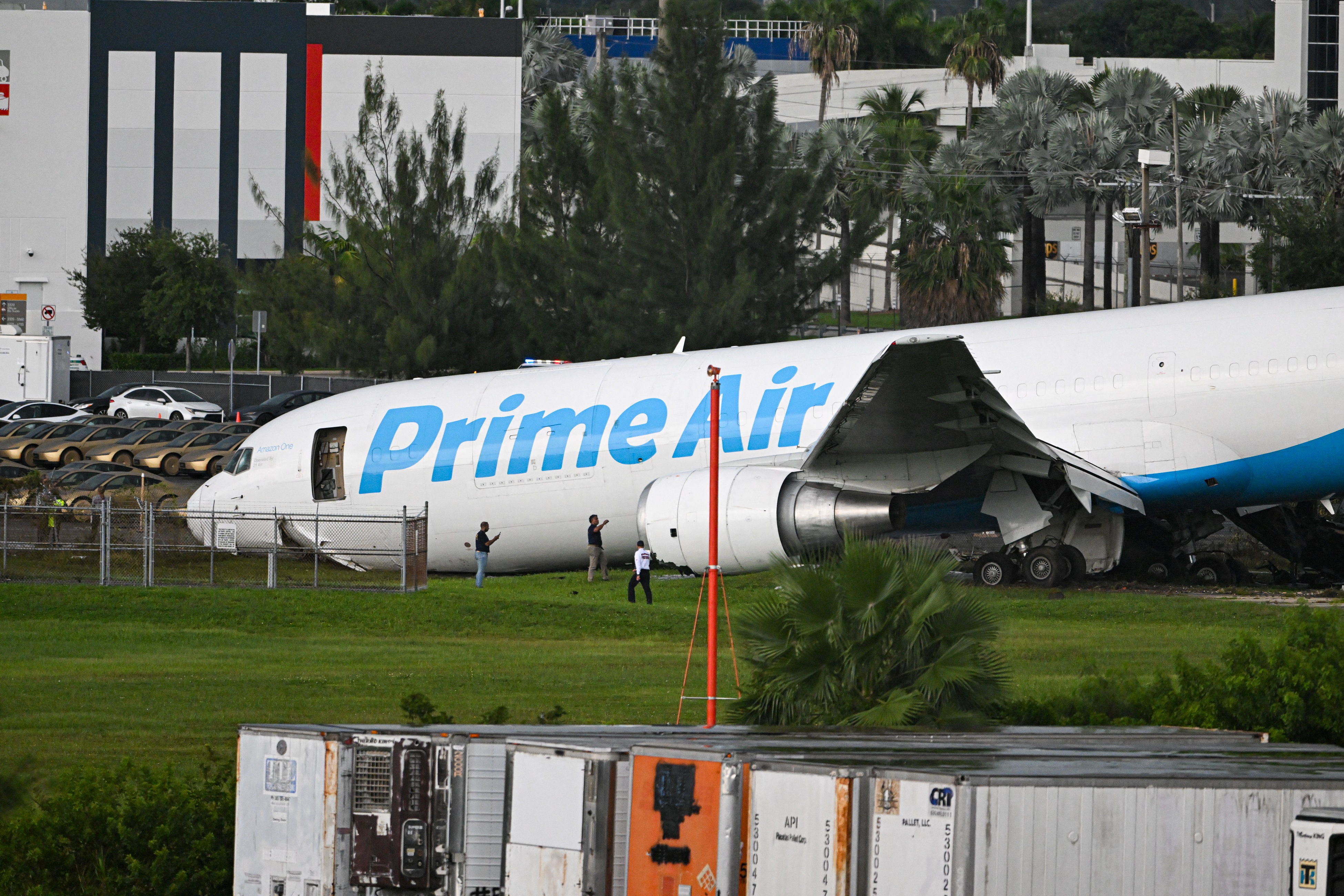 The damaged Prime Air aircraft came to rest beyond Miami International Airport's operational boundary after overrunning the runway. The crash sparked a fire and brought more than 60 Miami-Dade Fire Rescue units to the scene. | Source: Getty Images