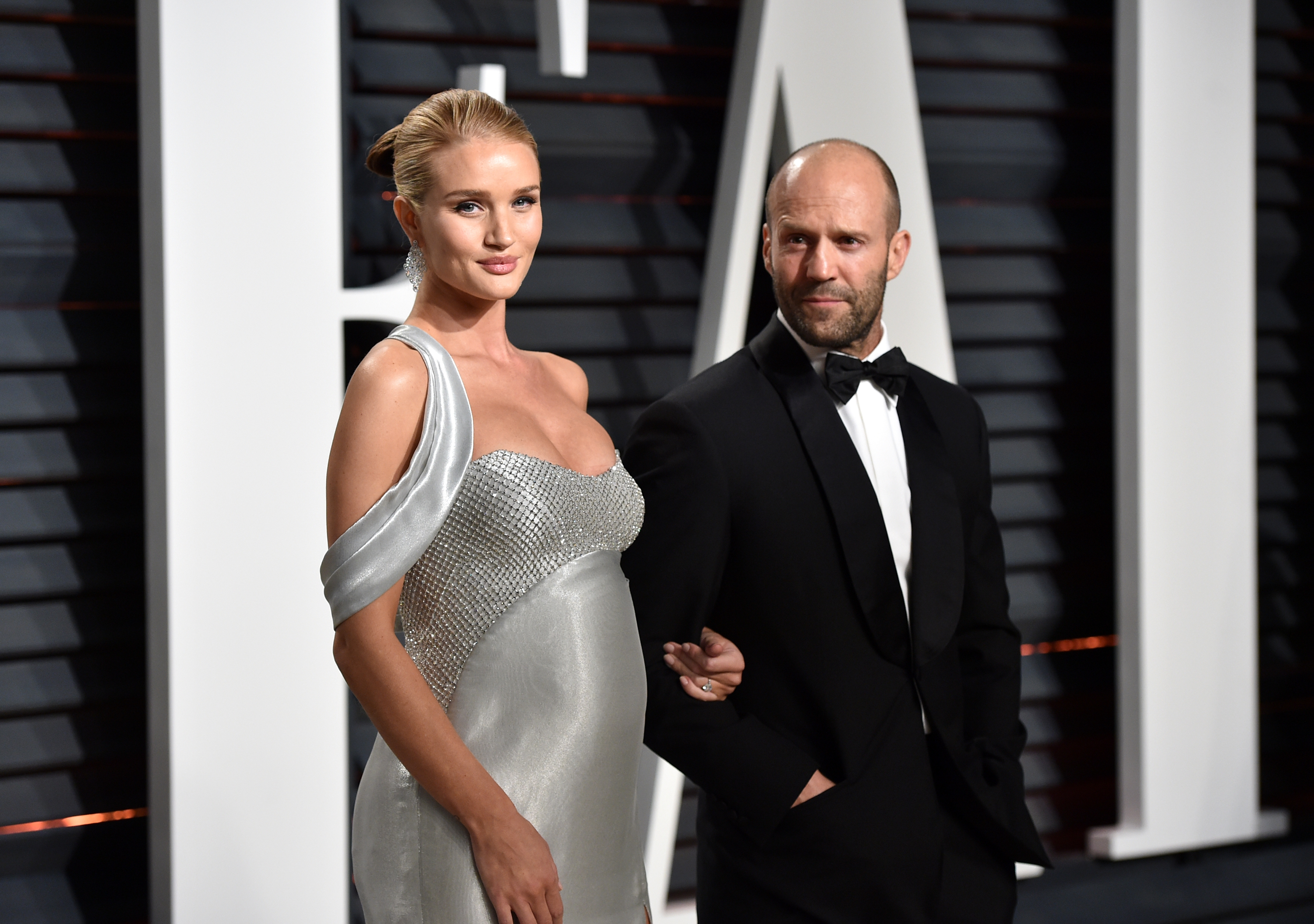 Rosie Huntington-Whiteley and Jason Statham embody effortless elegance at the Vanity Fair Oscar Party in 2017. | Source: Getty Images