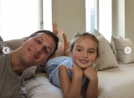 A sweet throwback selfie captured Arabella as a toddler lounging on a couch beside her smiling father, Jared Kushner. Propped up on her elbows in a light blue sleeveless outfit, little Arabella beamed at the camera, highlighting treasured early family memories included in the milestone tribute. | Source: Instagram/ivankatrump