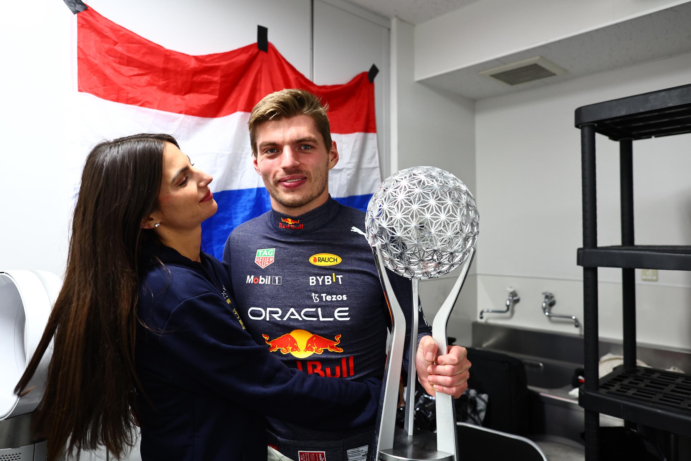 Max Verstappen celebrates with Kelly Piquet and his trophy after the Grand Prix of Japan at Suzuka International Racing Course in Suzuka, Japan, on October 9, 2022, capturing a moment of triumph as he had secured his second championship title.