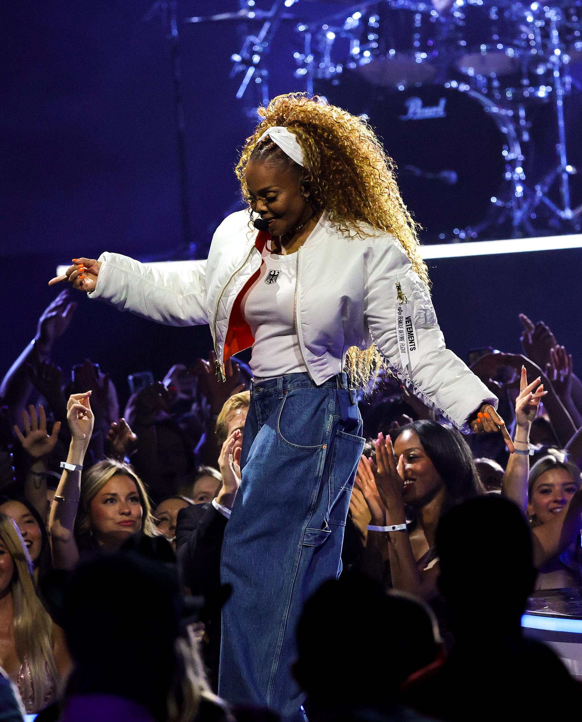 With the crowd at her feet, Jackson beams mid-performance, soaking in the electric energy of a roaring audience.