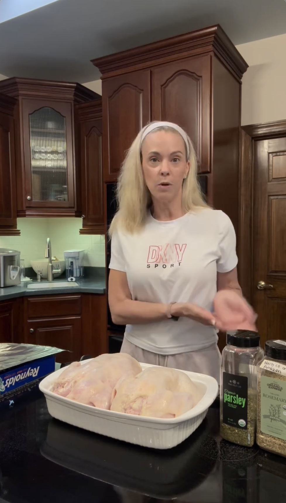Kate Gosselin gestures toward a tray of chickens while speaking to the camera. Surrounded by spices and ingredients, she explains her steps, giving followers a candid look at her cooking routine. | Source: Instagram/kateplusmy8