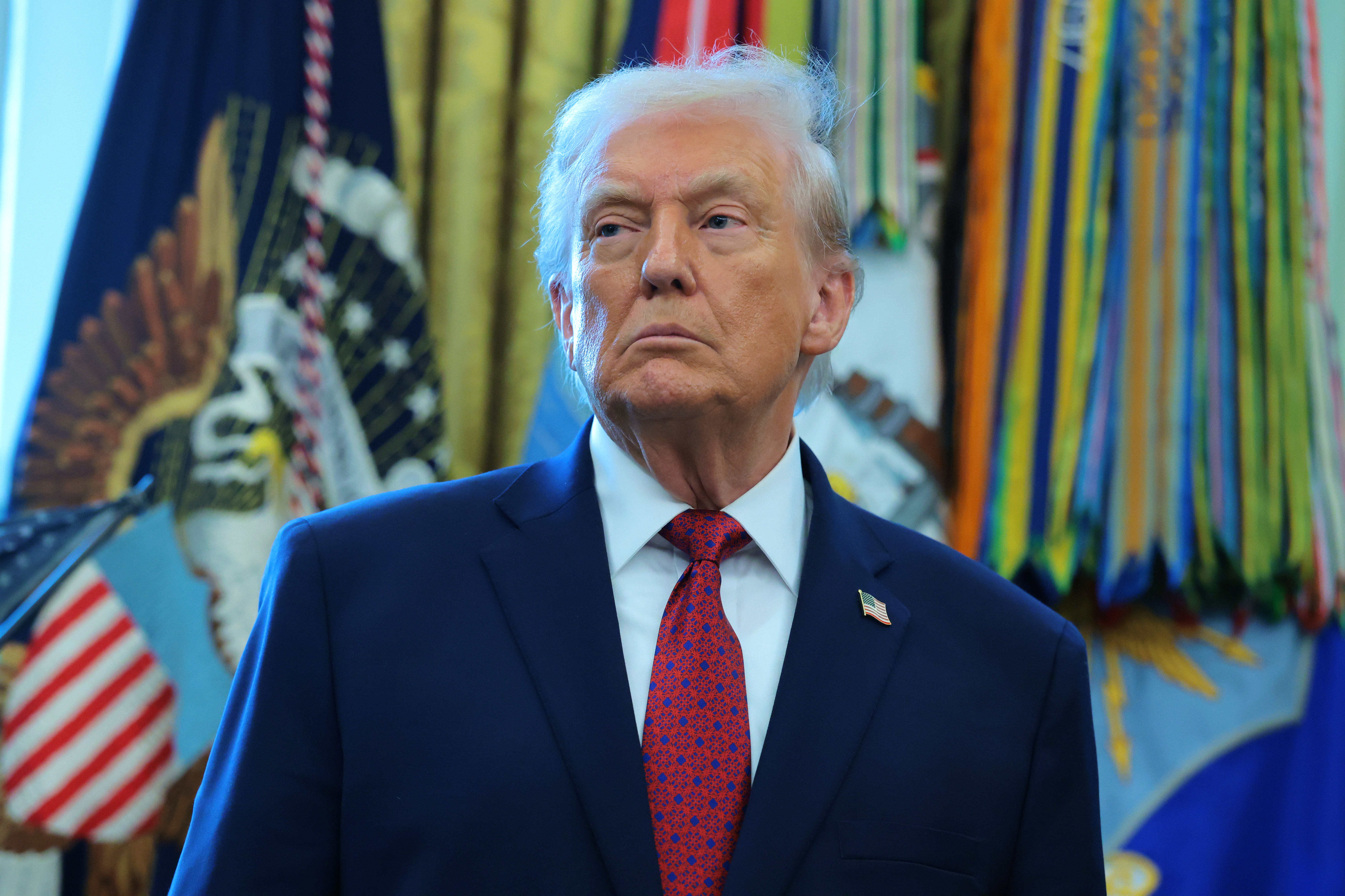 Donald Trump listens during the Mexican Border Defense Medal presentation ceremony in the Oval Office of the White House on December 15, 2025, in Washington, DC | Source: Getty Images