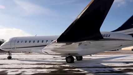 A Bombardier Global Express XRS sits parked on a snow-covered tarmac. | Source: YouTube/@WorldOfLuxuryOfficial