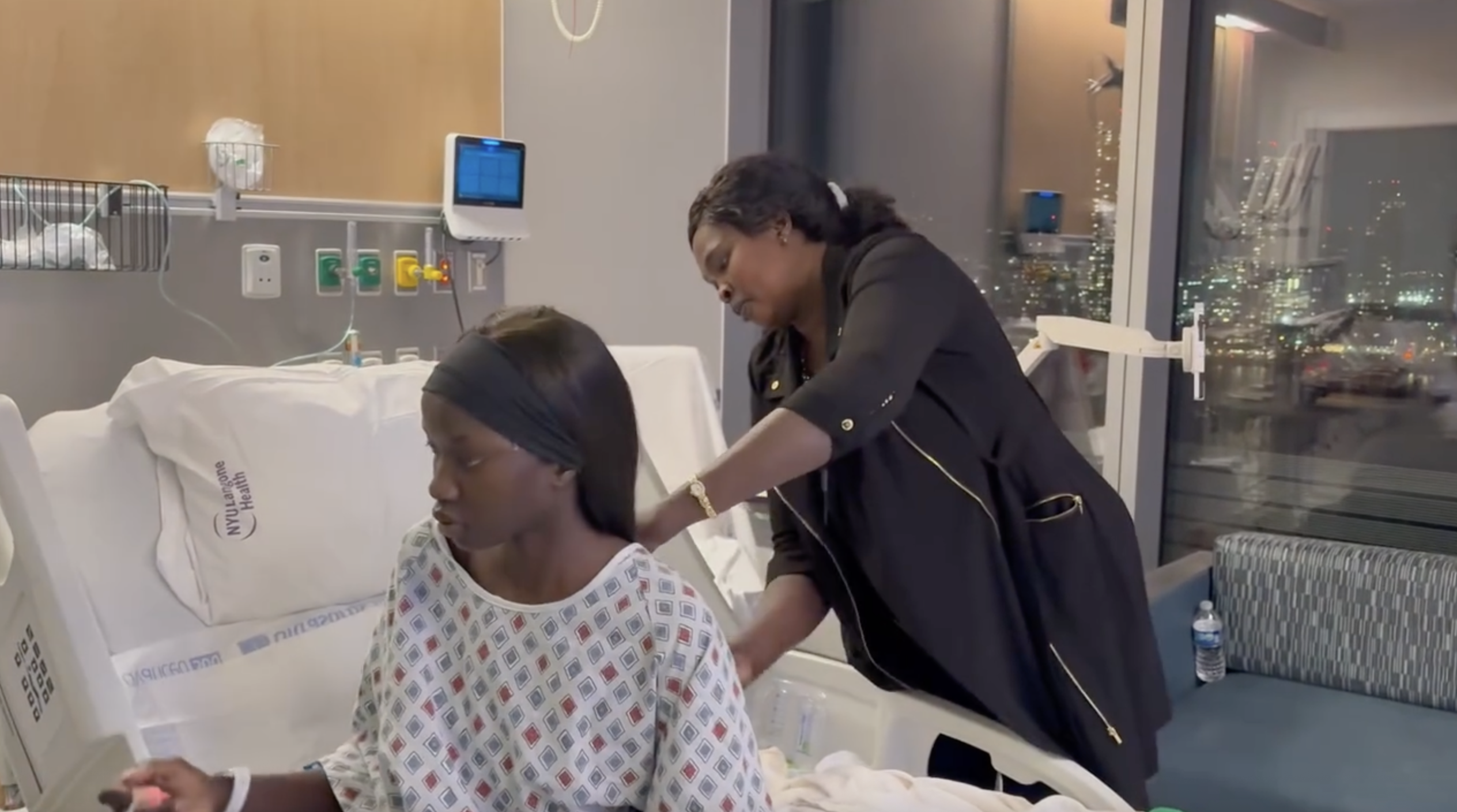 Anok Yai receives care from a family member after her robotic lung surgery | Source: Instagram/anokyai