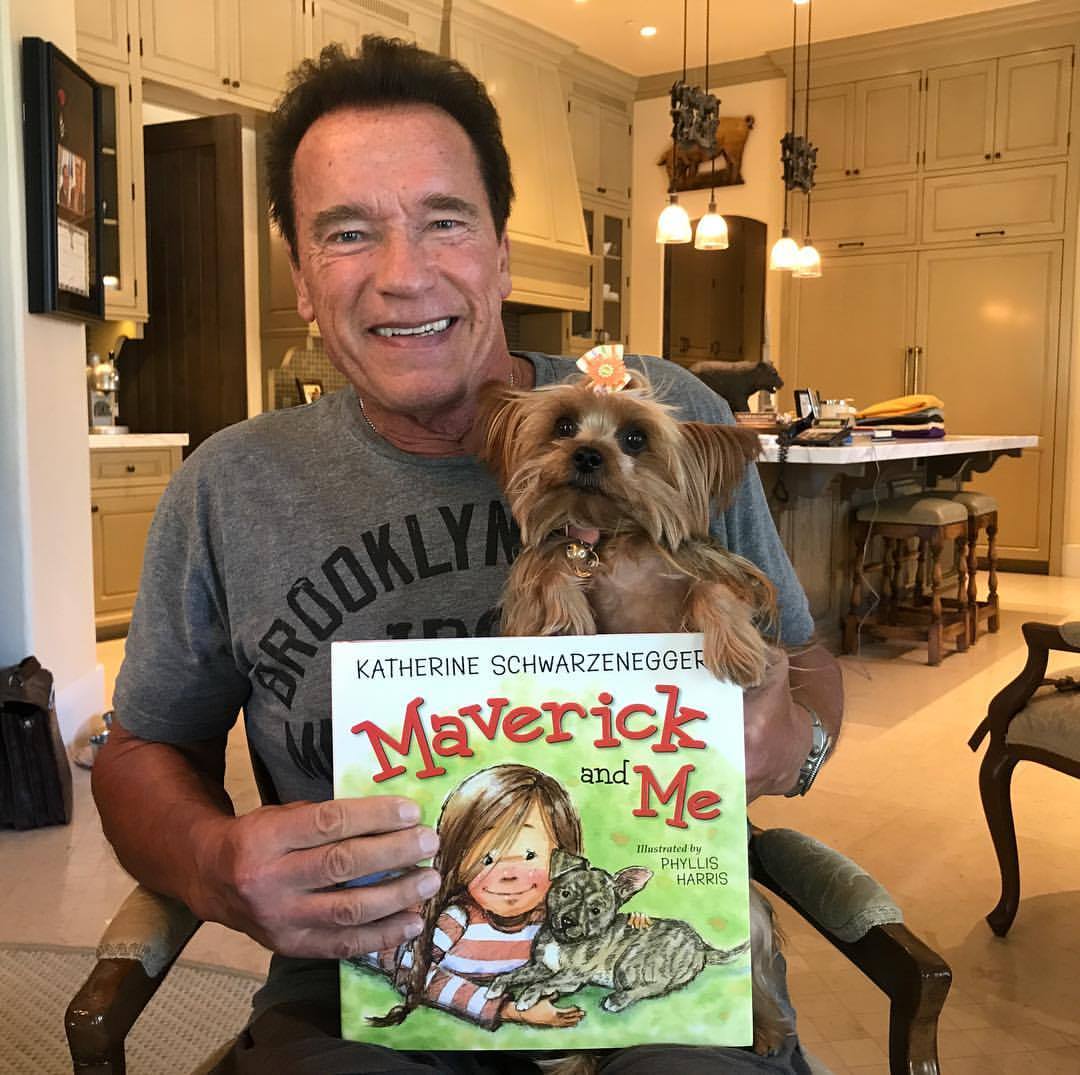 Arnold Schwarzenegger holds his dog and daughter Katherine’s book "Maverick and Me" in a photo posted on September 5, 2017 | Source: Facebook/arnold