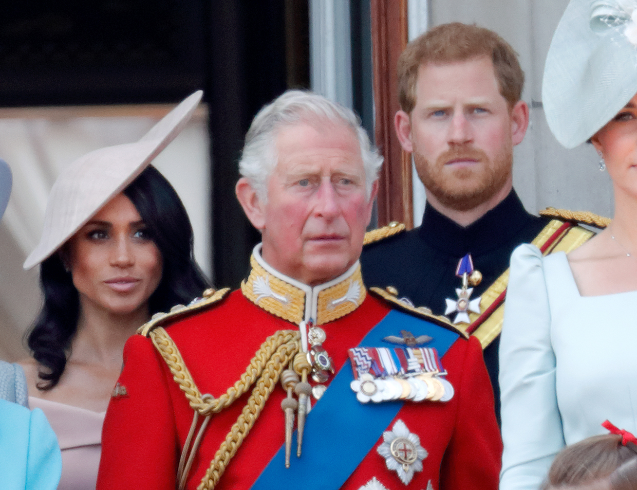 Prince Harry and Meghan Markle stand with King Charles III during Trooping the Colour in London in June 2018. The couple later stepped down from representative duties on behalf of the sovereign in January 2020. | Source: Getty Images