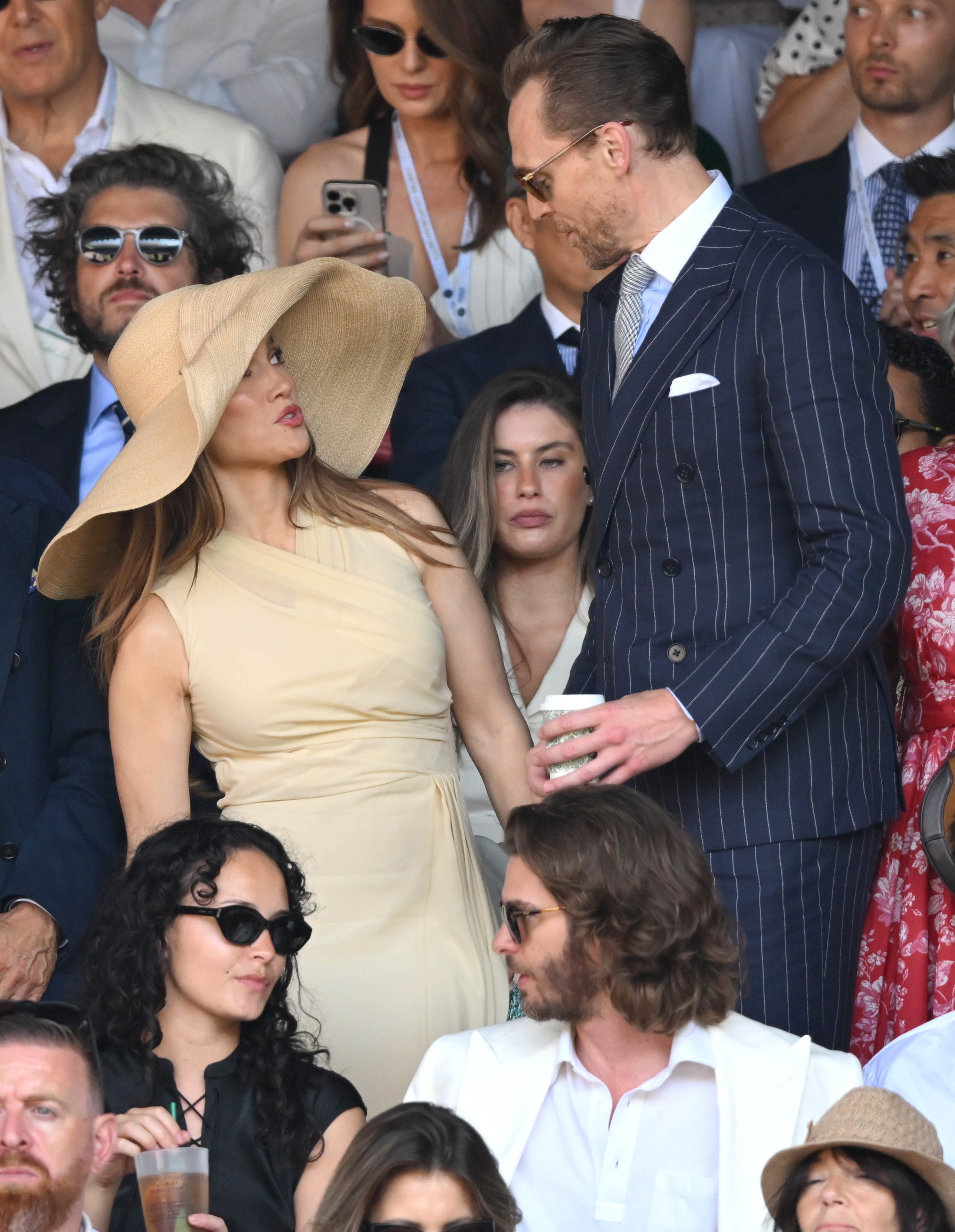 Lopez spent part of the final alongside Actor Tom Hiddleston, while Andrew Garfield was seated in the row below. Their proximity helped the images spread rapidly as viewers scrutinized the scale of her headwear. | Source: Getty Images