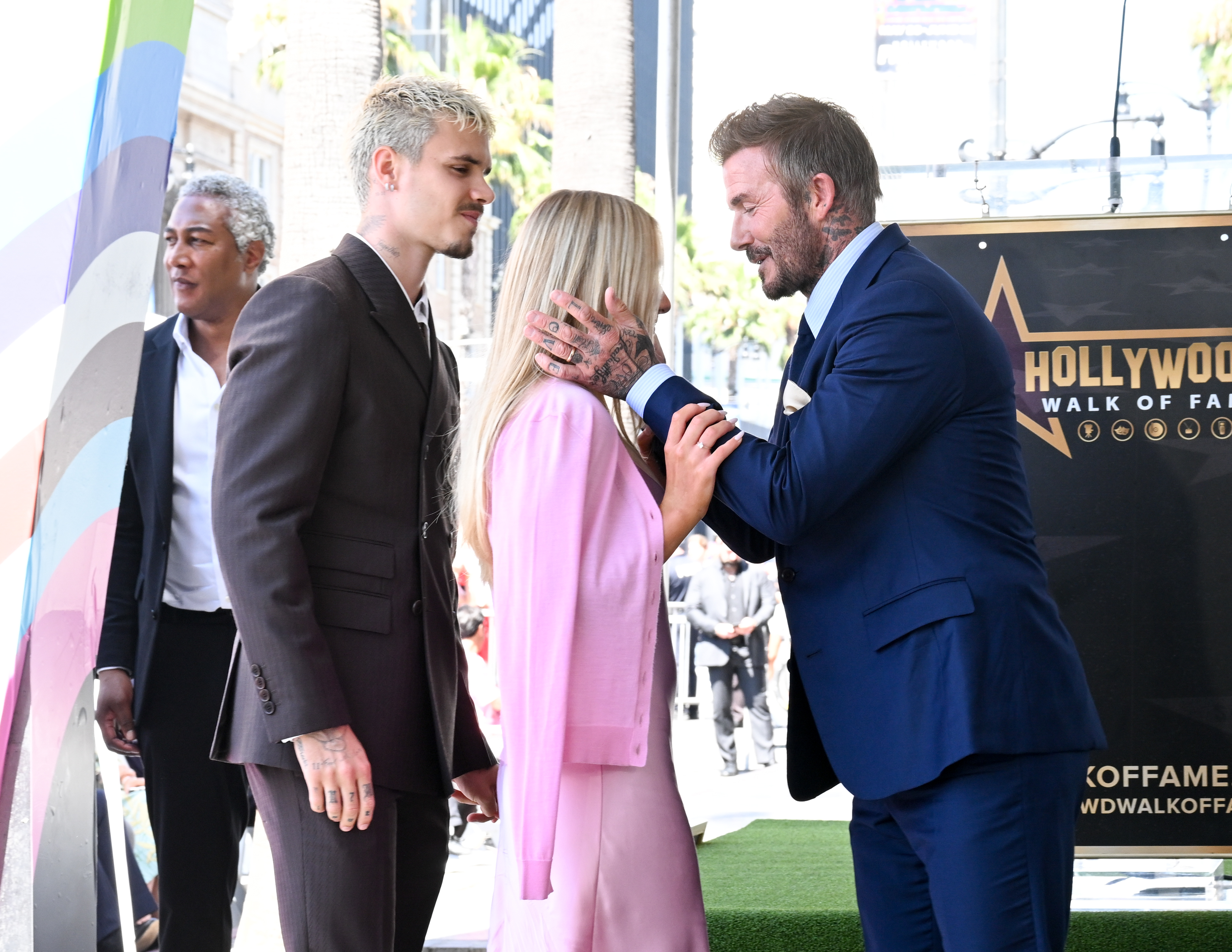 A particular exchange unfolded between the father and his daughter. At this moment, they were seen with Romeo Beckham as they prepared to take pictures at the ceremony. | Source: Getty Images