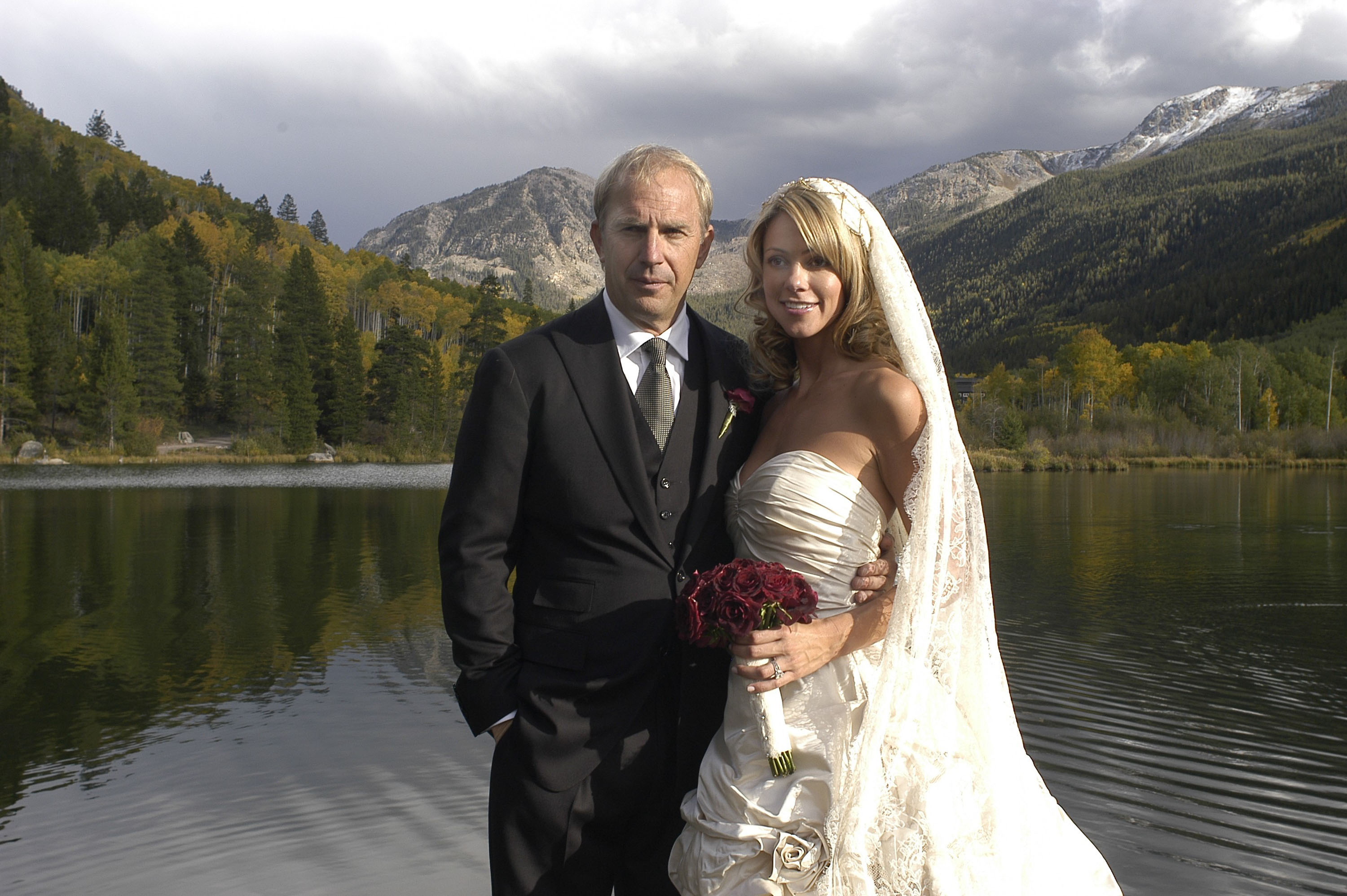 Kevin Costner and Christine Baumgartner pose on their wedding day at the actor's Colorado ranch near Aspen on September 25, 2004. Their three-day celebration followed a brief separation earlier in their relationship before they reconciled and committed to building a future together.