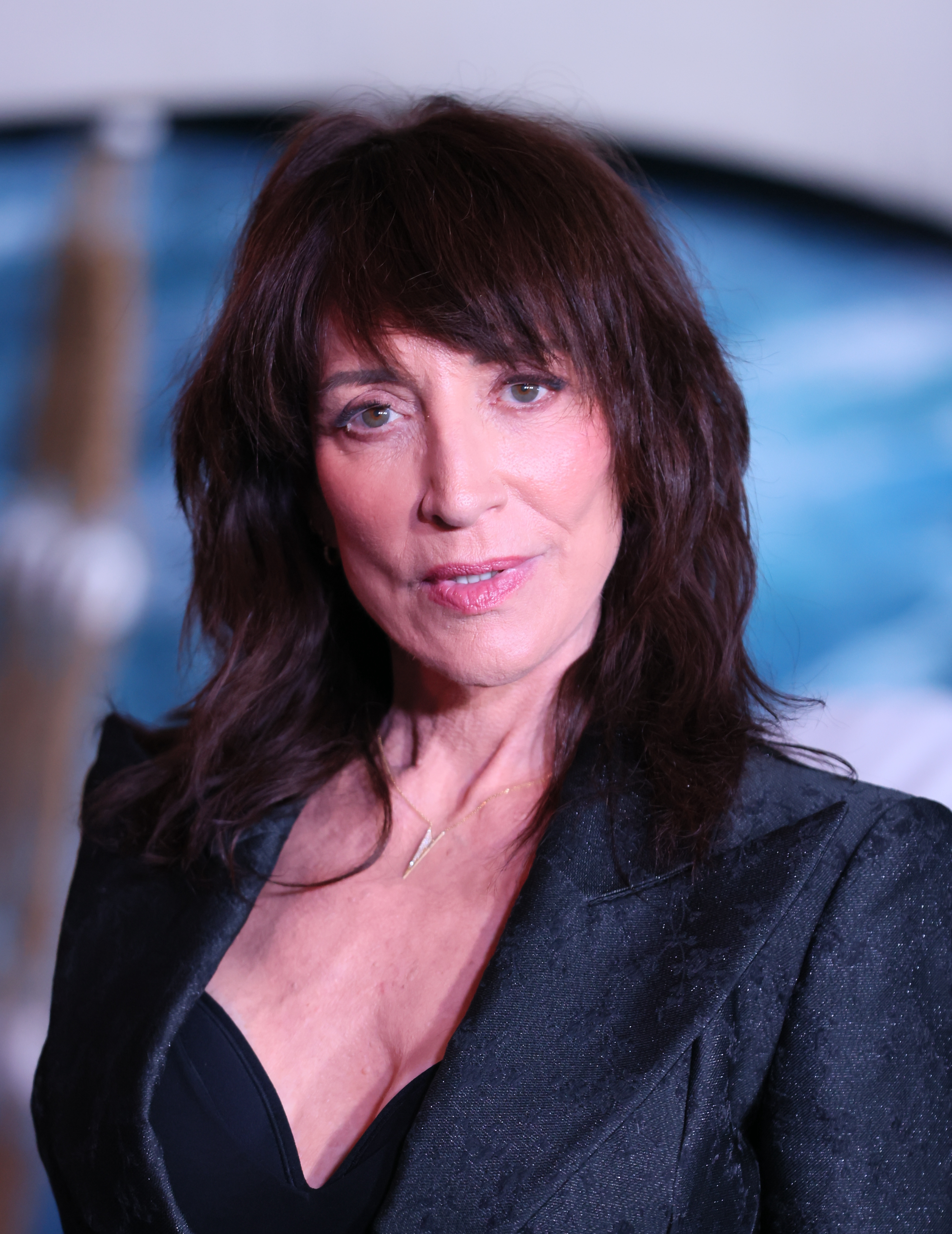 Katey Sagal brought chic rock-and-roll glamour to Netflix's "One Piece" Into The Grand Line fan event at The United Theater on Broadway on February 26, 2026, in Los Angeles, California. The Golden Globe–winning actress paired a textured black brocade blazer with a plunging neckline and a delicate gold geometric pendant, wearing her brunette hair in shaggy, layered waves with full fringe as she posed on the red carpet. | Source: Getty Images