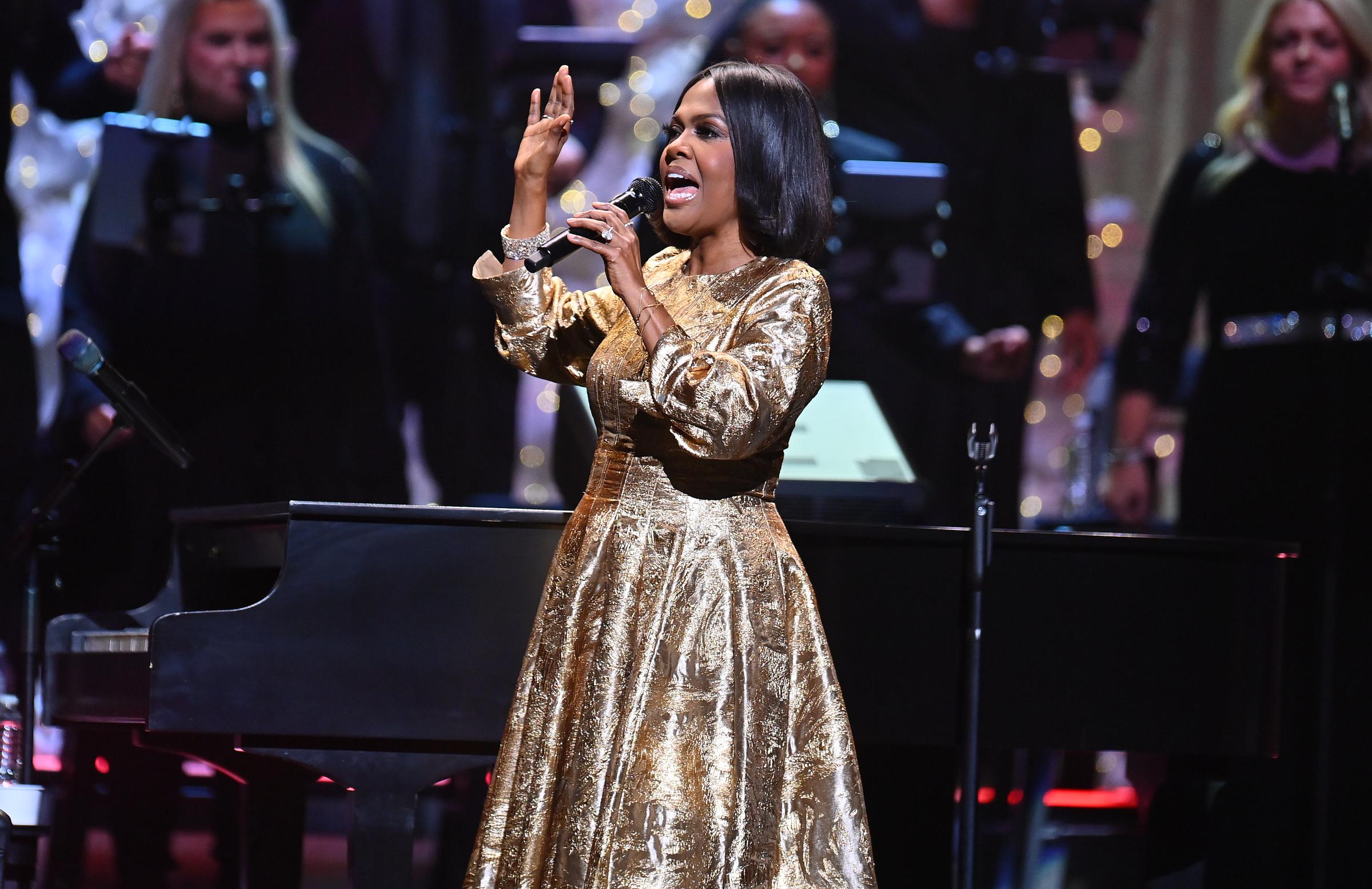 CeCe Winans raises her hand while singing onstage during the "Christmas Together" tour at The Fox Theatre in Atlanta, Georgia.