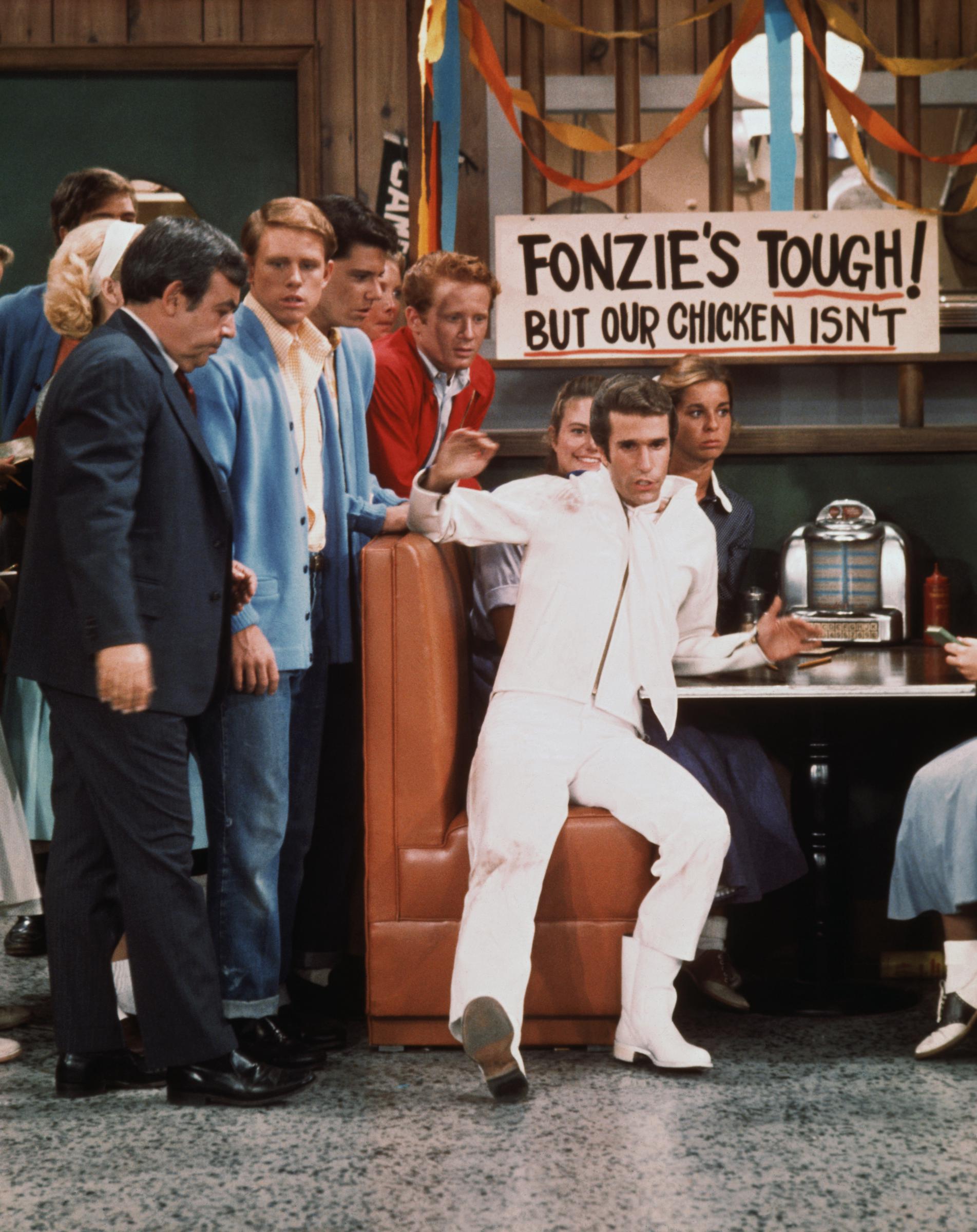 The actor, pictured at Arnold's Diner alongside his "Happy Days" co-stars, was part of the beloved sitcom's ensemble cast during its 1974–1984 run. | Source: Getty Images
