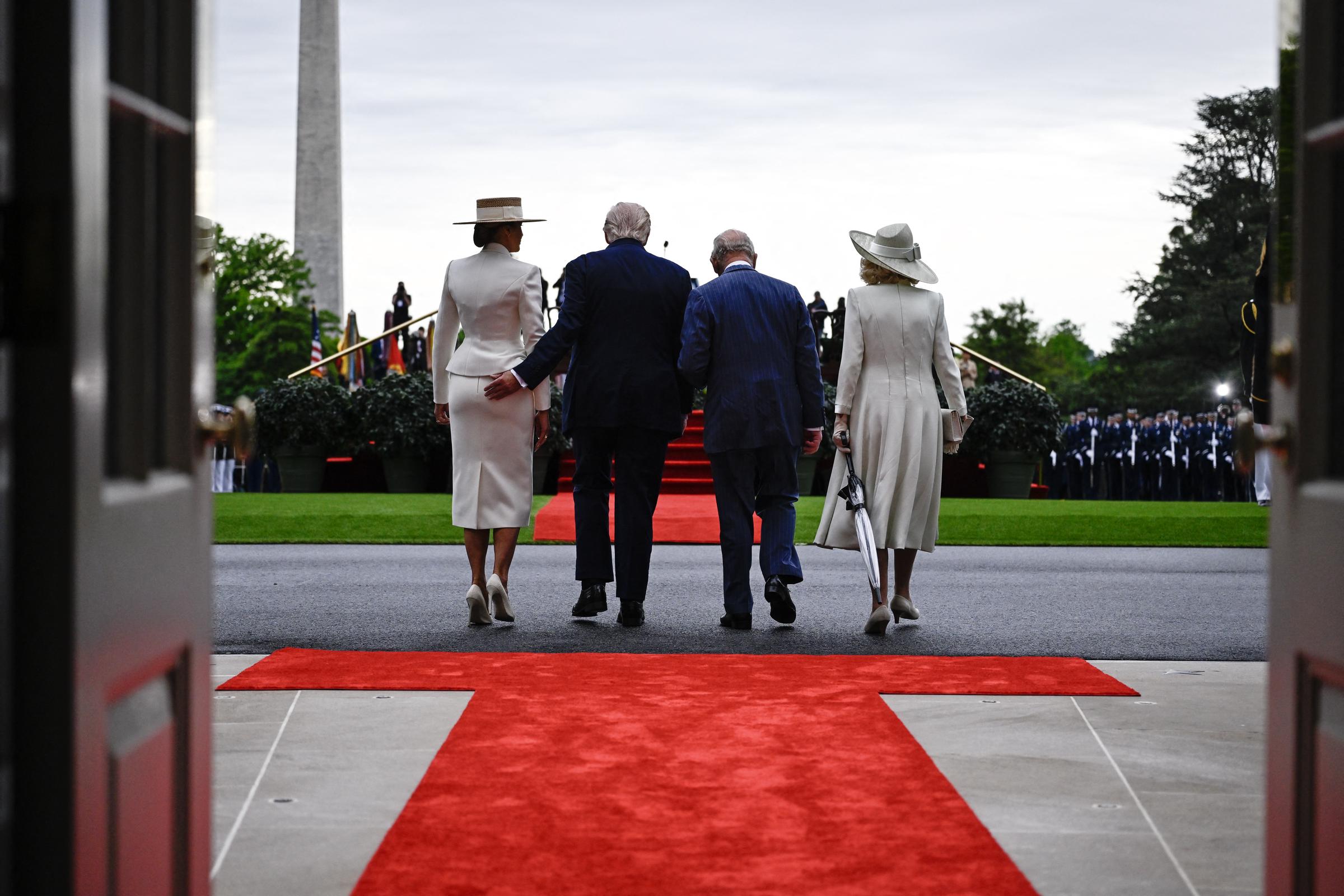 Donald Trump giving Melania Trump's backside a light tap, as the pair walk alongside Queen Camilla and King Charles III during the royal couple's arrival ceremony in Washington, D.C., on April 28, 2026. | Source: Getty Images