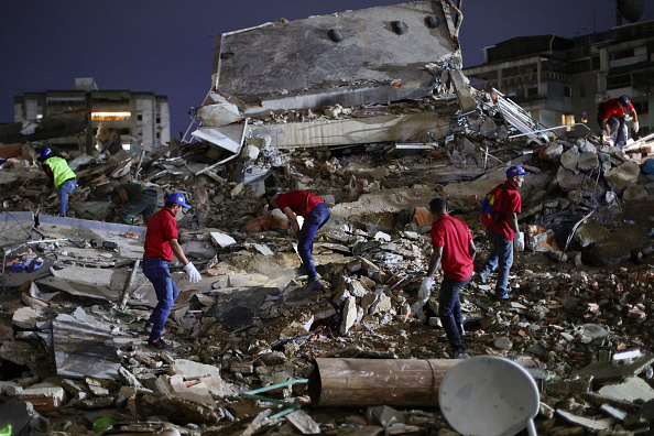 Rescue workers search through the rubble of a collapsed building for victims in the San Bernardino neighborhood after a magnitude 7.2 earthquake struck Venezuela and other parts of the Caribbean on June 24, 2026, in Caracas, Venezuela. | Source: Getty Images
