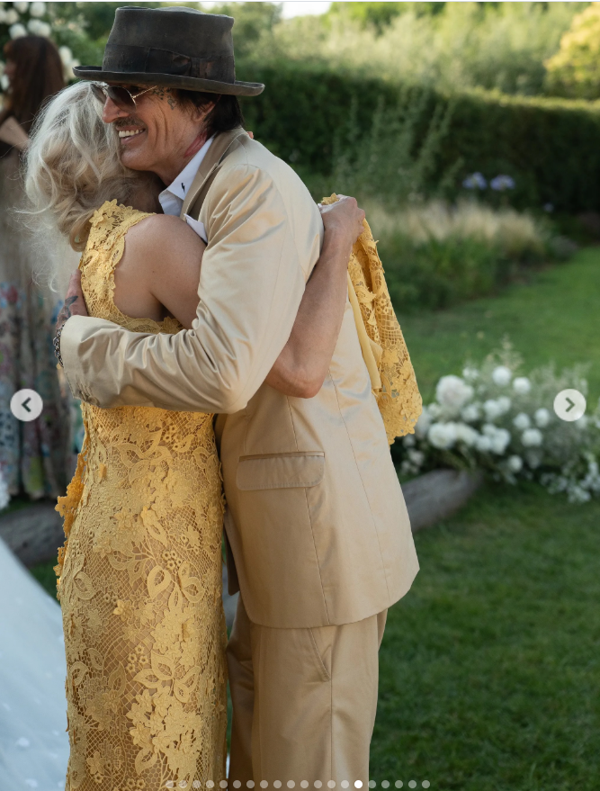 Pamela shared a warm embrace with Tommy Lee during the celebration, with her mustard lace dress and his coordinating neutral suit creating a softly matched moment between the former couple. | Source: Instagram/thierryjoubertphotography
