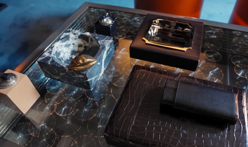 The accessories lean into the cigar-room fantasy. It is all very polished, but still playful. | Source: YouTube/Architectural Digest
