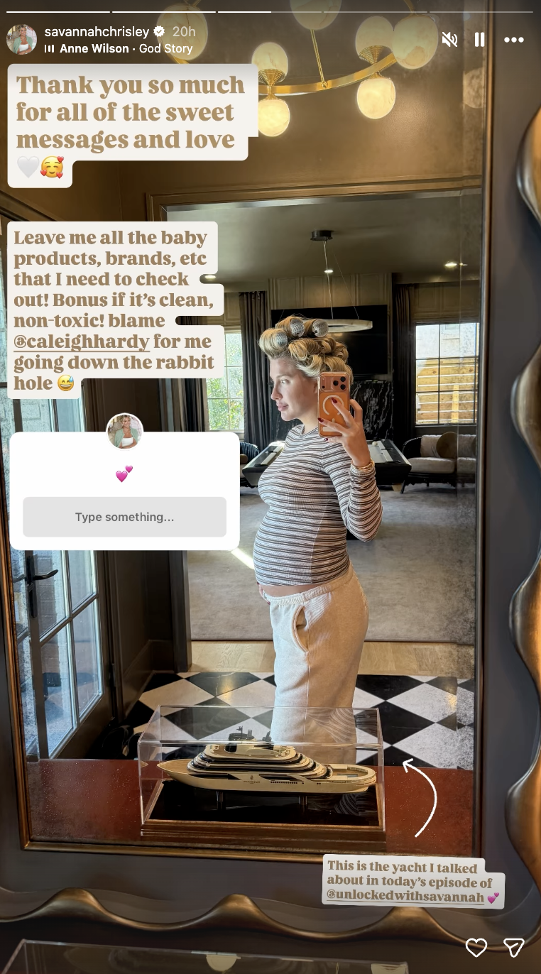 Savannah Chrisley shows off her growing baby bump in a side-profile mirror selfie on October 27, 2026, dressed in light-colored sweatpants and a striped long-sleeved top with oversized curlers in her hair, posing beside a glass-cased model yacht. | Source: Instagram/savannahchrisley