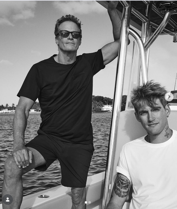 Rande Gerber and son Presley Gerber posed together aboard a boat on open water in a sleek black-and-white portrait shared by Cindy Crawford for Father's Day on June 15, 2025, with Rande looking cool in sunglasses and shorts while Presley relaxed in a classic white T-shirt showcasing his arm tattoos. | Source: Instagram/cindycrawford