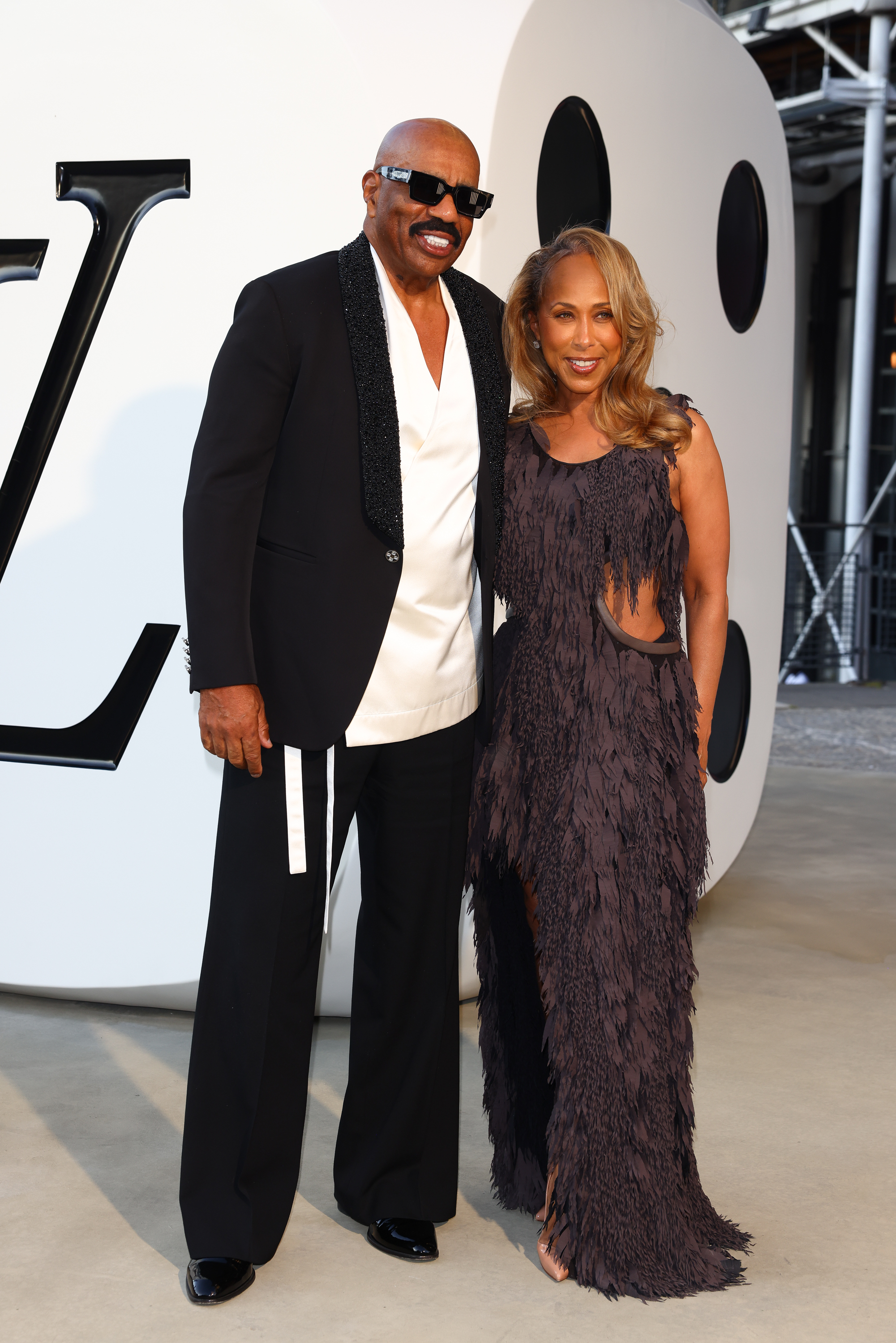 Majorie and Steve Harvey pose for photos at the Louis Vuitton Menswear Spring/Summer 2026 show as part of Paris Fashion Week in Paris, France on June 24, 2025 | Source: Getty Images