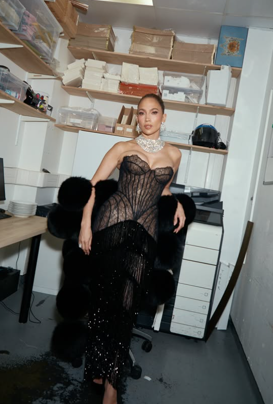 Jennifer closed the carousel with a striking portrait in a sheer black gown accented by sparkling jewelry and a dramatic wrap. The final image shifted from intimate family moments back to the glamorous persona that has long defined her public image. | Source: Instagram/jlo