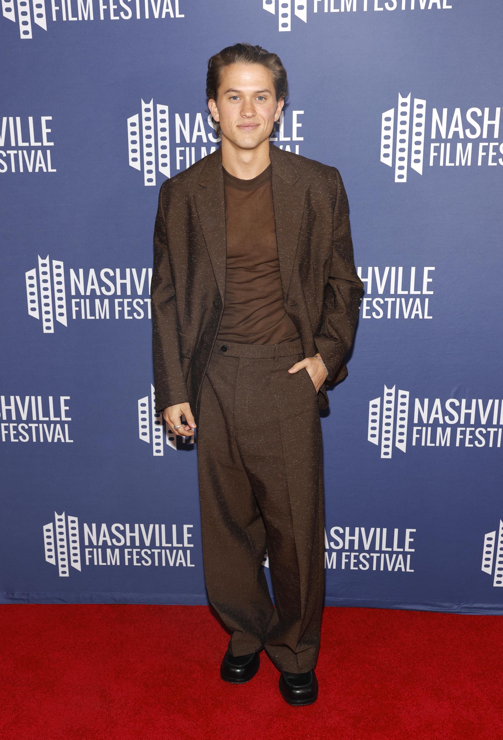 A full-length view completed the picture, with wide-leg trousers and black shoes finishing Deacon's head-to-toe brown ensemble. The relaxed silhouette stood apart from the more traditional suits he wore to Hollywood events growing up.