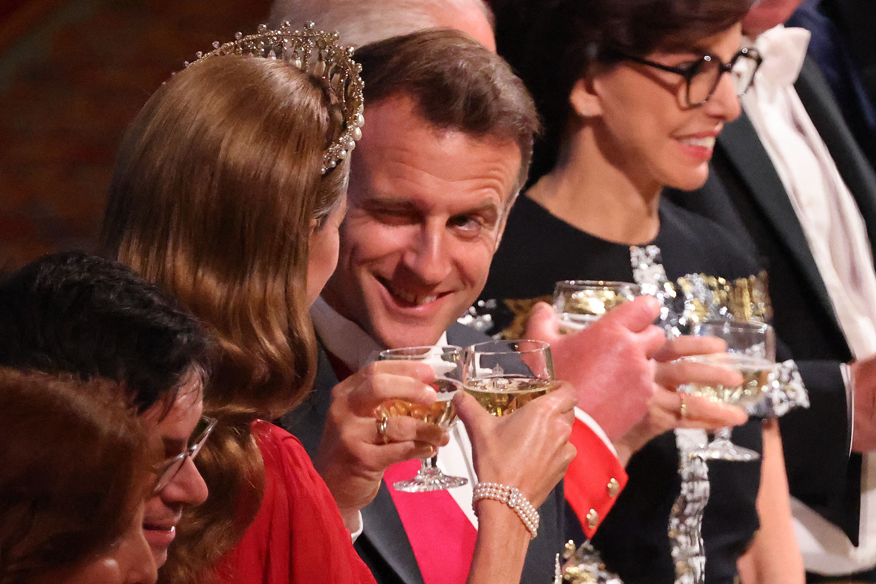 President Emmanuel Macron makes a toast with Britain's Catherine, Princess of Wales during a State Banquet at Windsor Castle, west of London, on July 8, 2025. The French President winks at the Princess, sparking speculations and diverse interpretations online.
