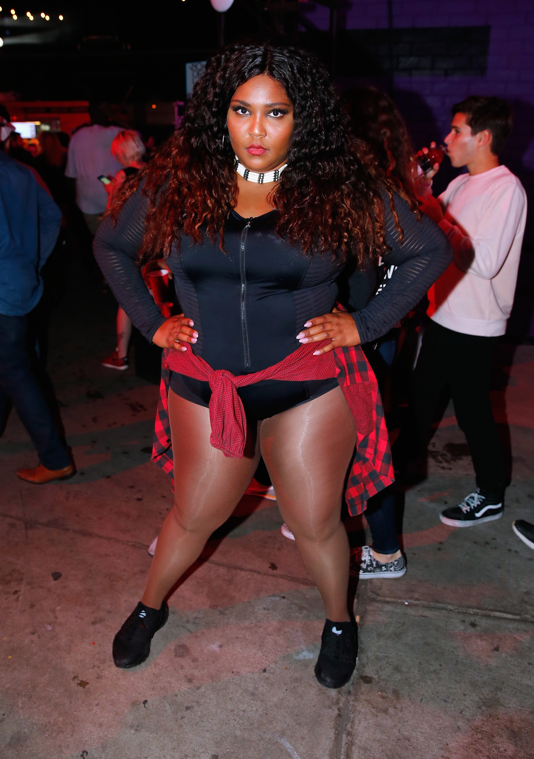 Posing with hands on her hips, Lizzo meets the camera with a fierce, unflinching gaze, fully owning the moment and the space around her. In a bold, body-celebrating look, she signals a defining shift — confidence no longer emerging, but firmly established.