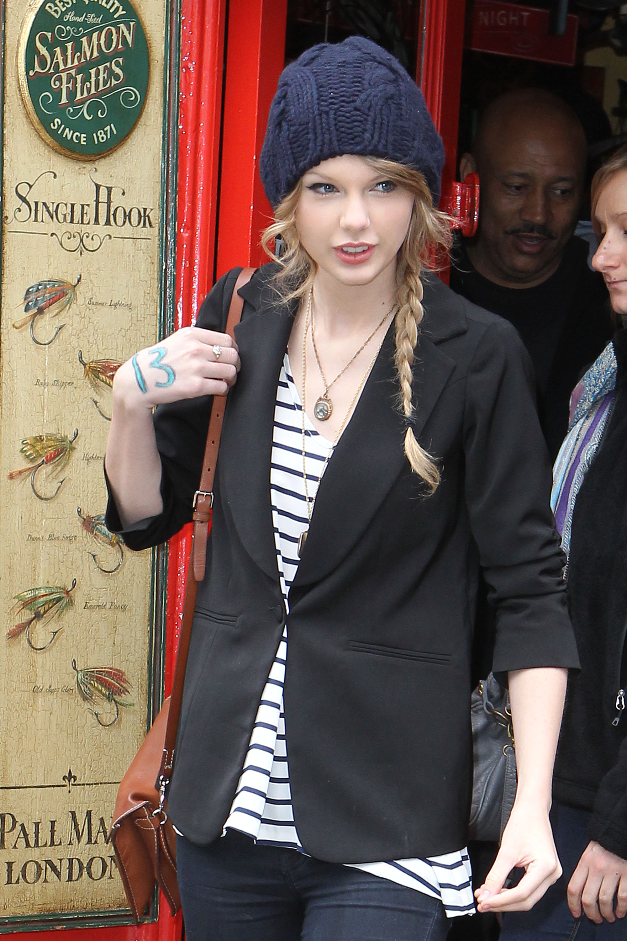Even outside of events, Taylor Swift looks effortlessly charming in a casual outfit, topped with a beanie partly covering her hair. Her cheeks appear sweetly chubby, and her eyes sparkle with vibrancy as she walks out of an antique shop on Portobello Road in London, England.