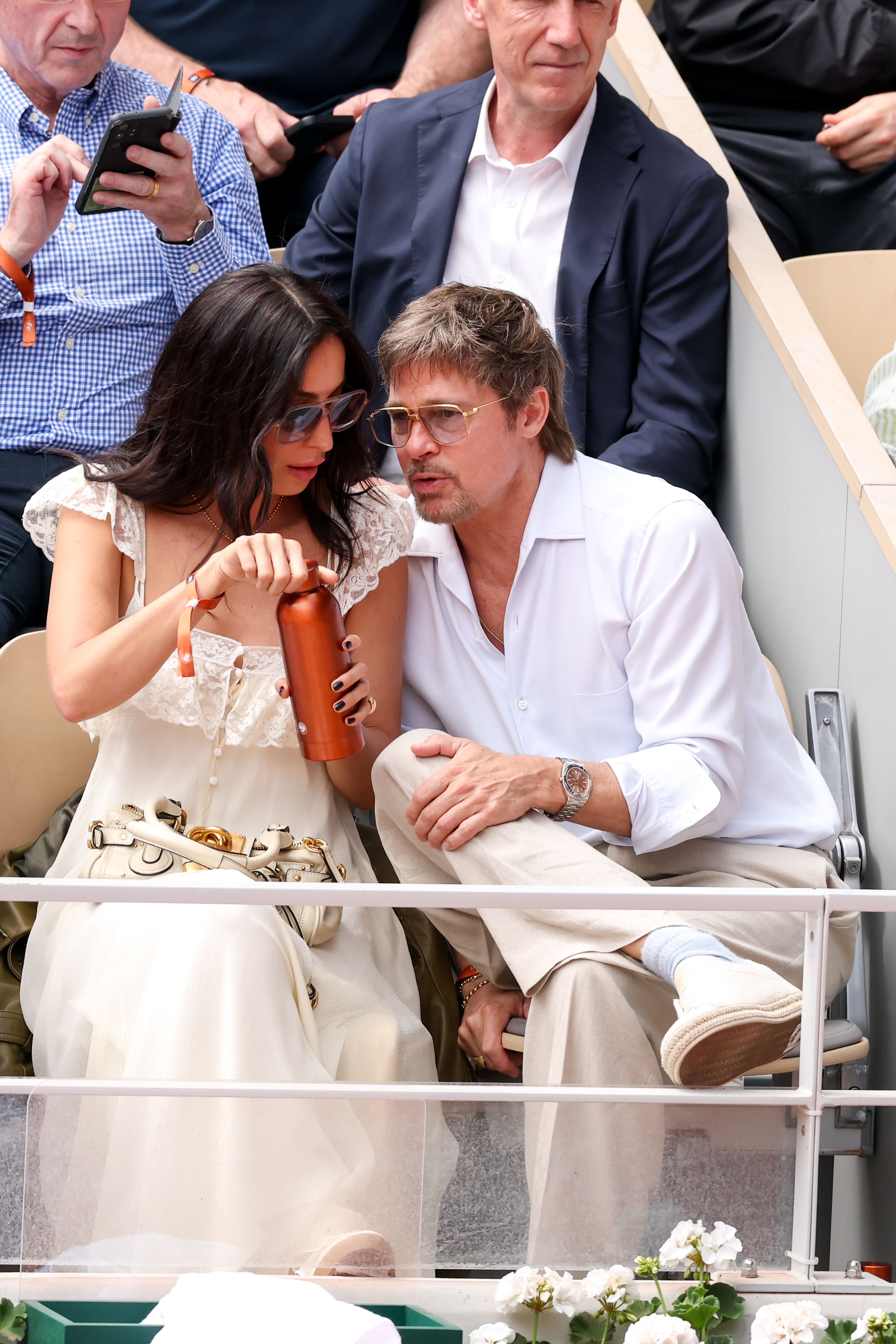Brad Pitt and Ines de Ramon sit together during a June 2026 outing, appearing relaxed as they watched the action from the stands. | Source: Getty Images